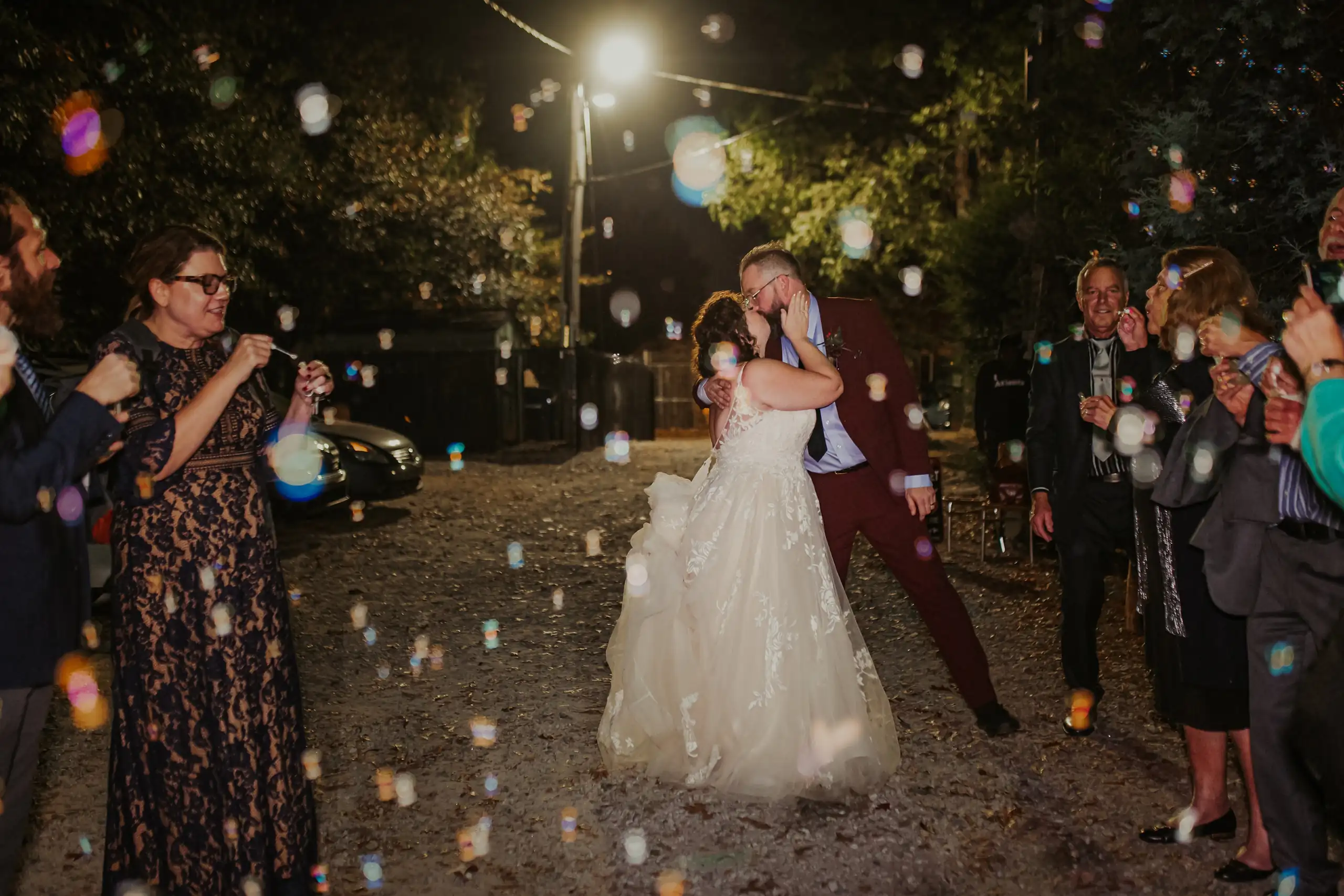 Send-Off: the couple walking out through bubbles and lights, at their wedding at Wahoo! Grill in Decatur, GA
