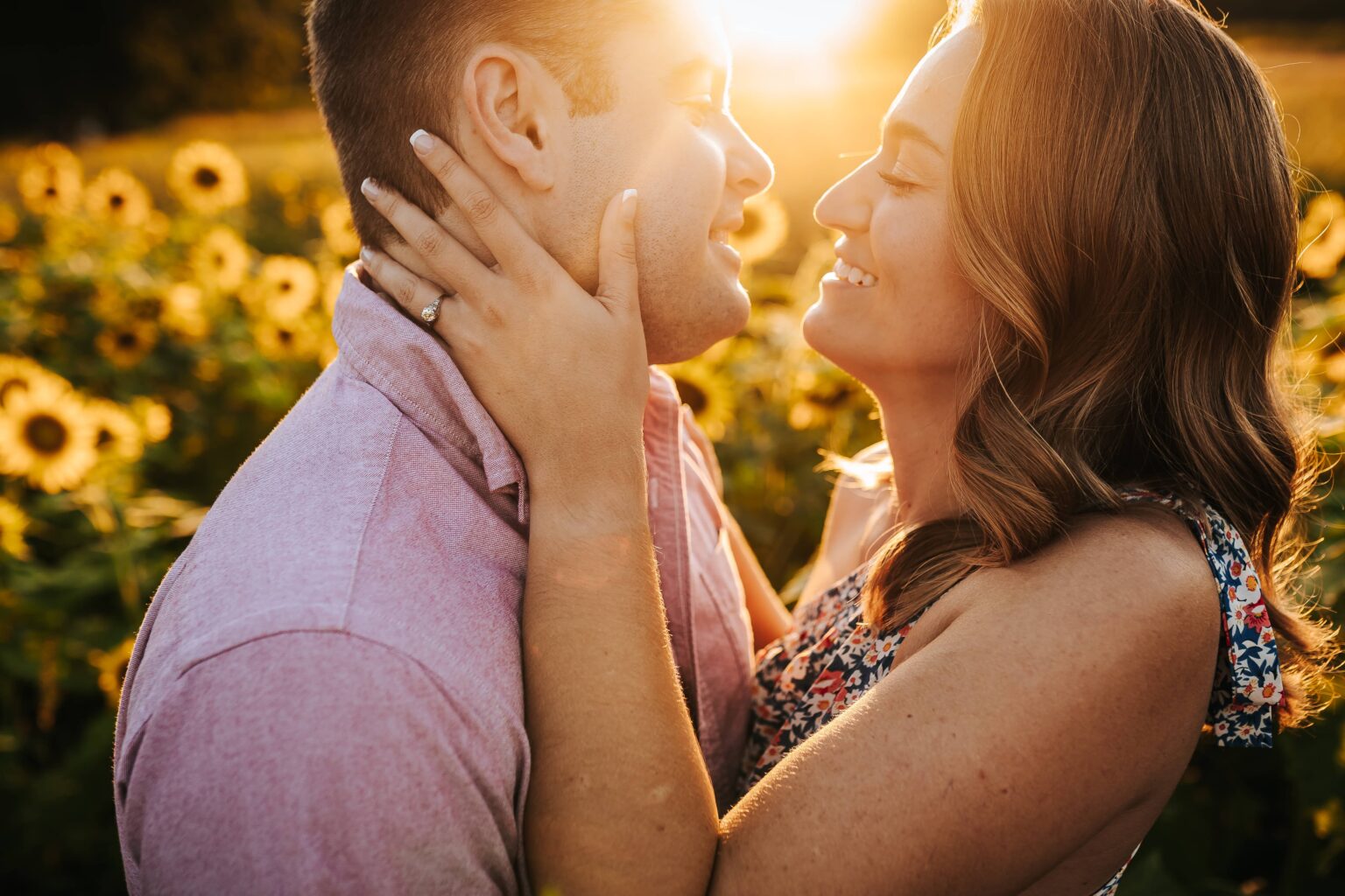 Couple in a sunflower field at sunset during their engagement session at Prospect Farms