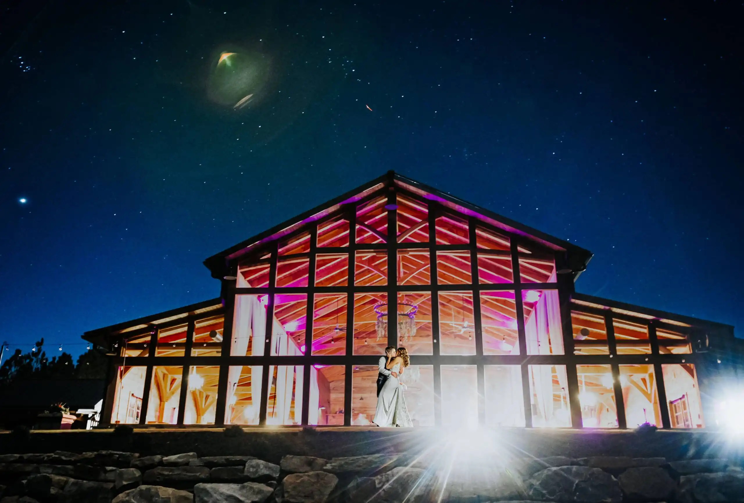 Wedding Formals: the lit venue against a starry sky at night, at their wedding at The Venue at Sharp Mountain in Jasper, GA