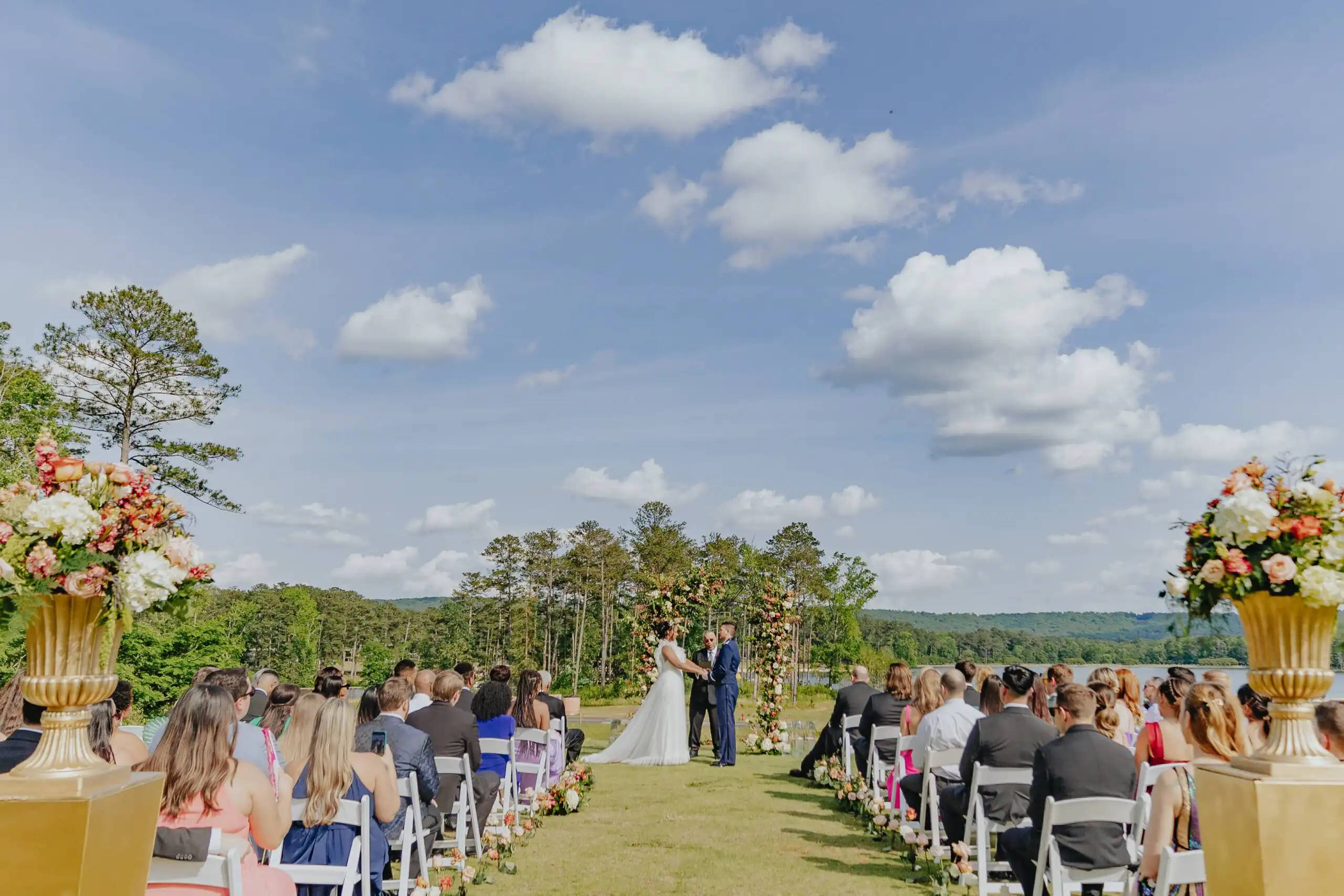 Wedding Ceremony: the whole lawn from the back of the aisle, the lake beyond, at their wedding at Callaway Gardens in Pine Mountain, GA