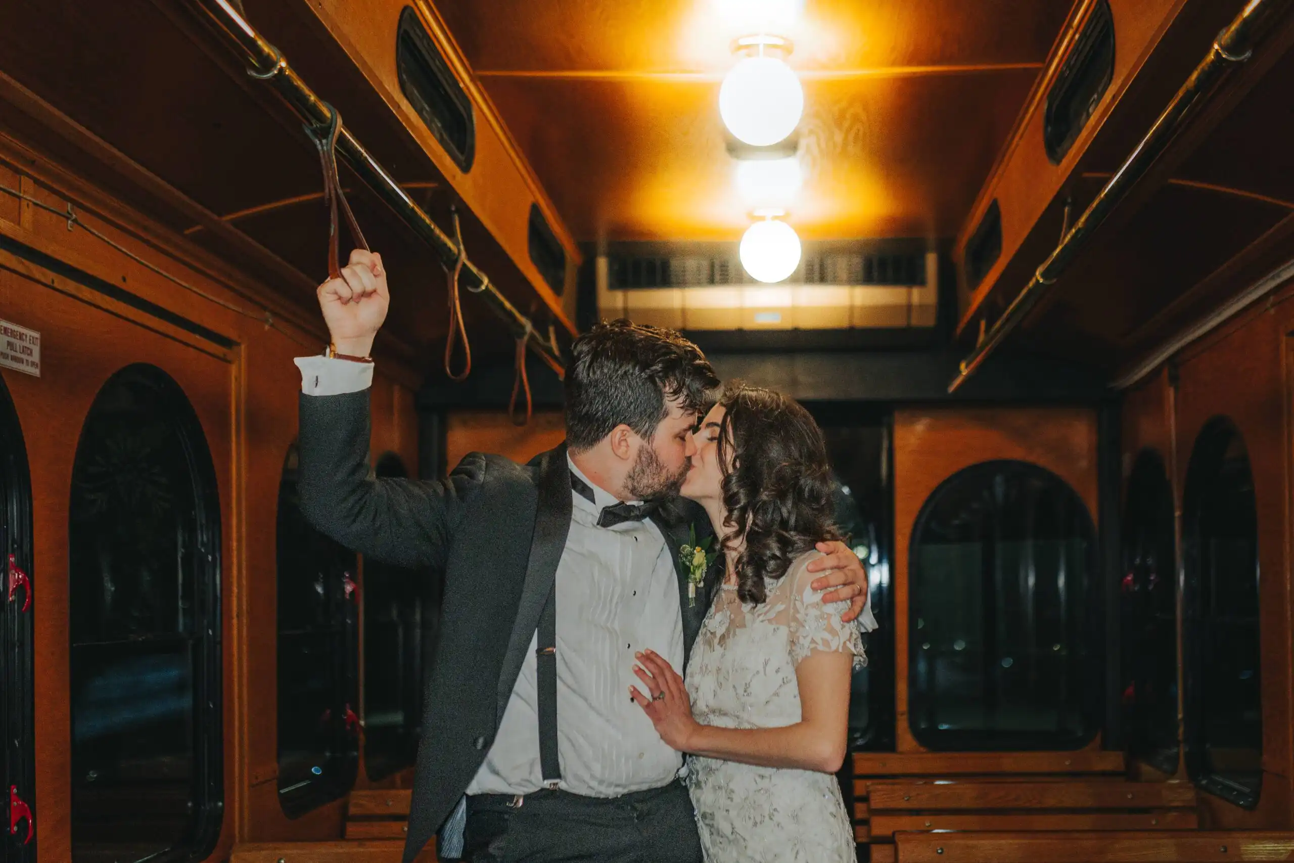 Wedding Reception: the two of them kissing inside the trolley, at their wedding at the Trolley Barn in Atlanta, GA