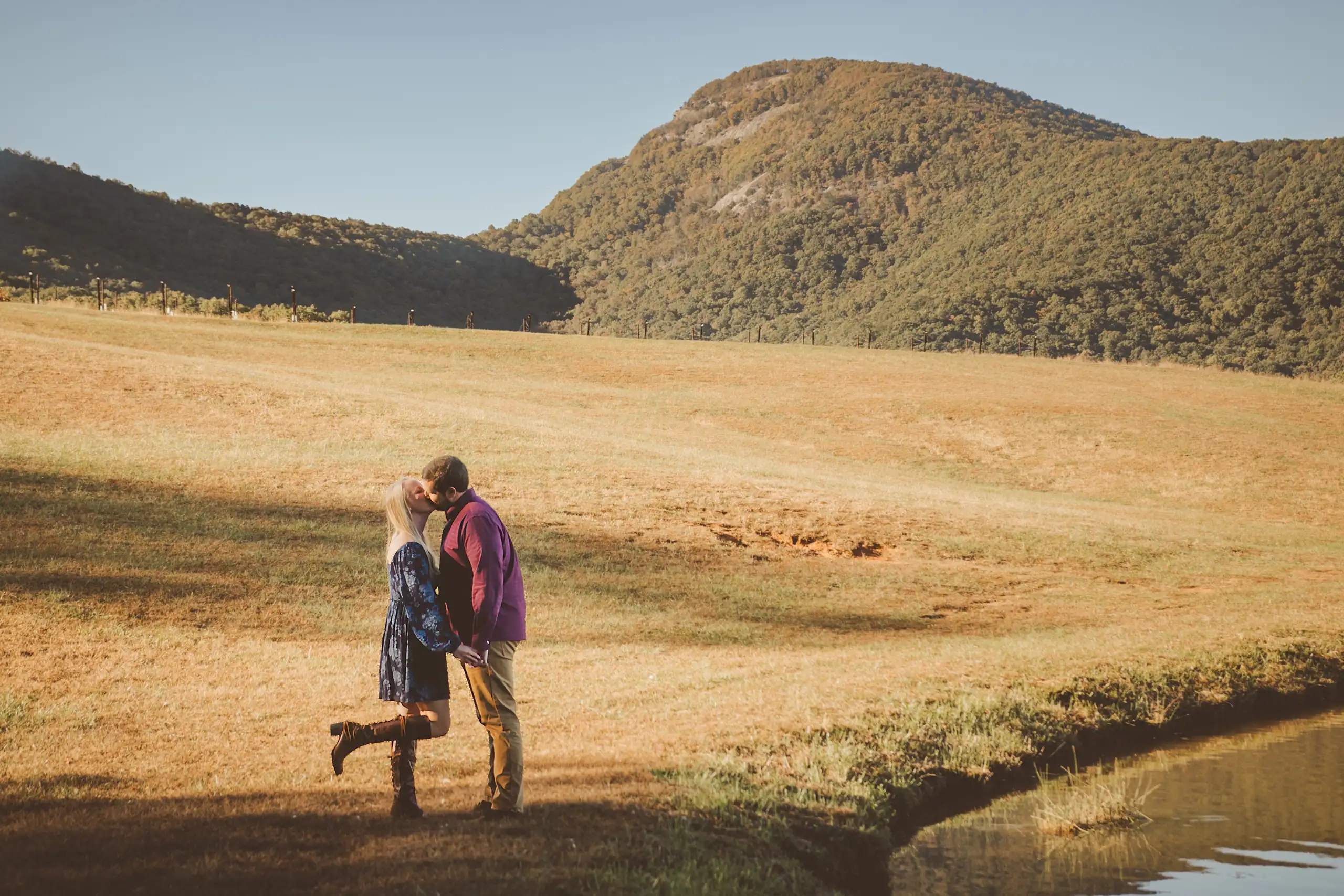 Engagement Portraits: the couple small in the valley below the mountain, during their engagement session