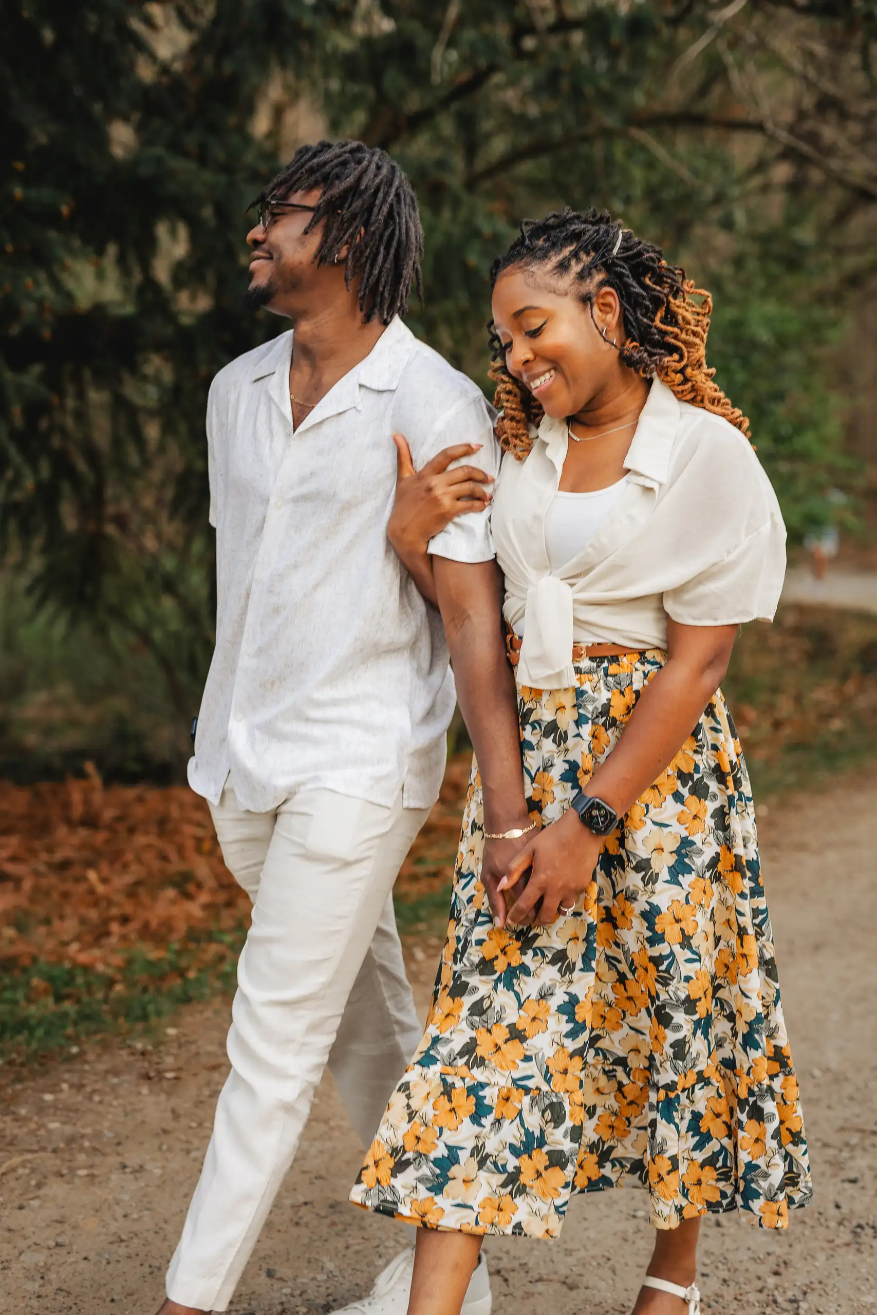 Engagement Portraits: the two of them walking the wooded path together, during their engagement session at Lullwater Preserve in Atlanta, GA