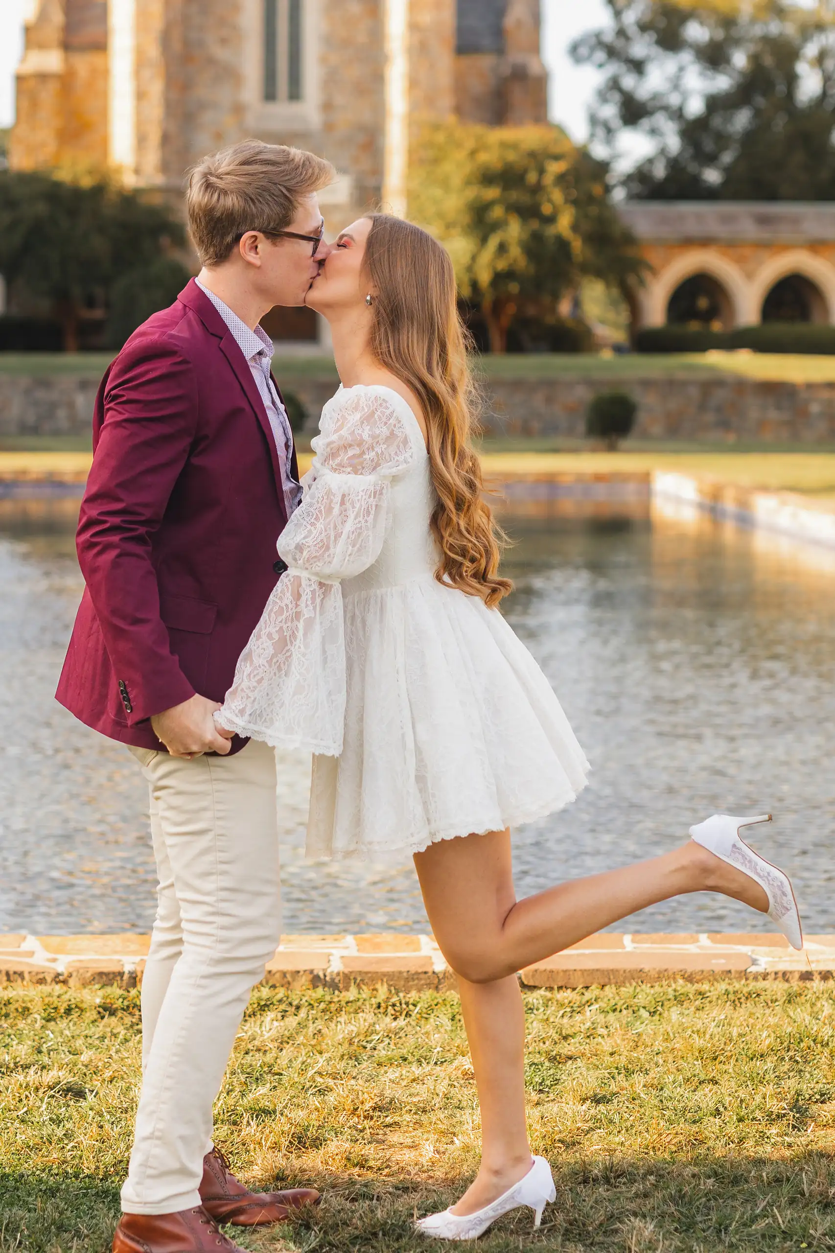 Engagement Portraits: the couple by the reflecting pool at the stone buildings, during their engagement session at Berry College in Rome, GA