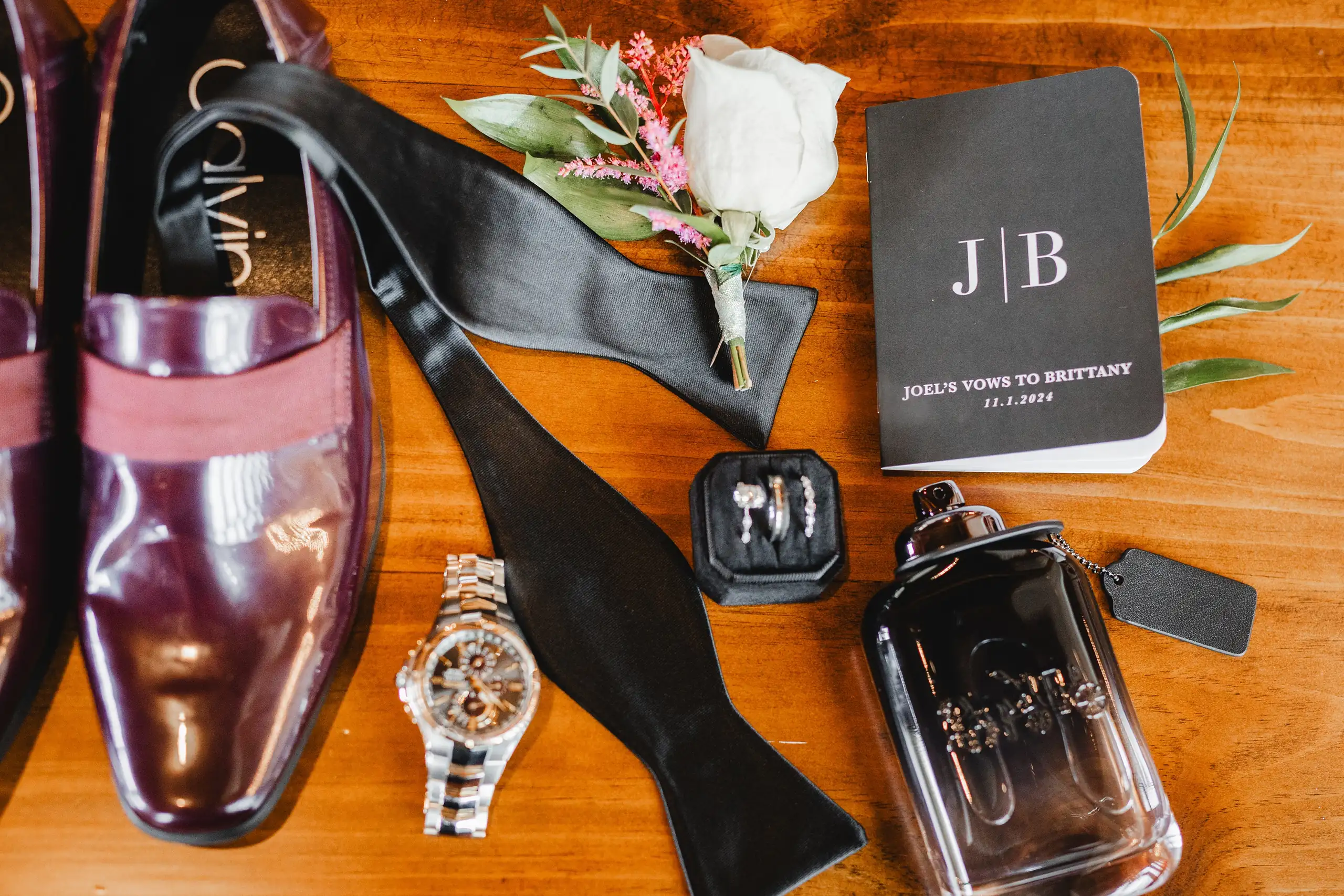 Wedding Details: the groom's shoes, watch, tie and vow book laid out, at a wedding at The Venue at Sharp Mountain in Jasper, GA