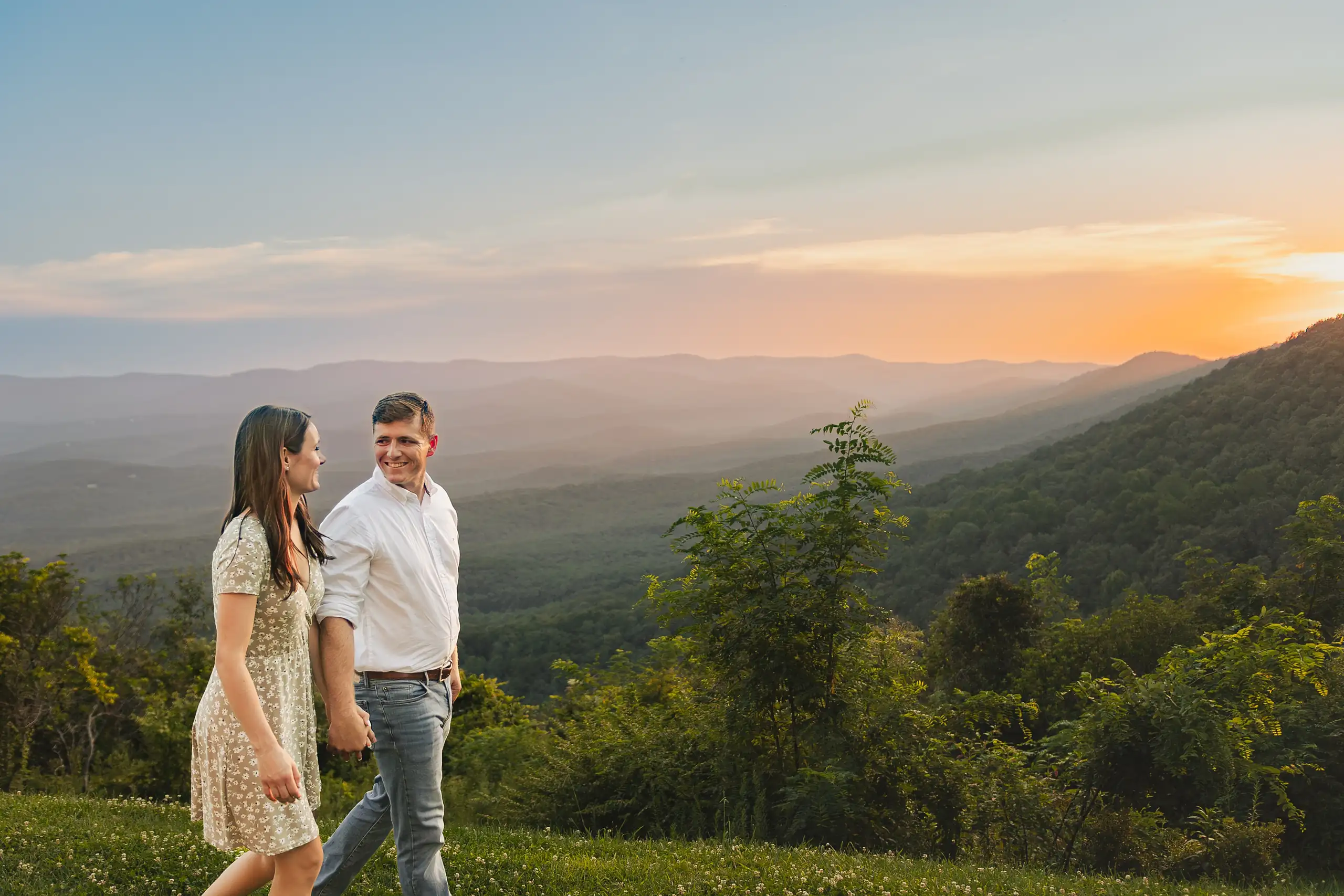 Engagement Portraits: the couple walking the ridge as the sun goes down, at their engagement session at Amicalola Falls in Dawsonville, GA