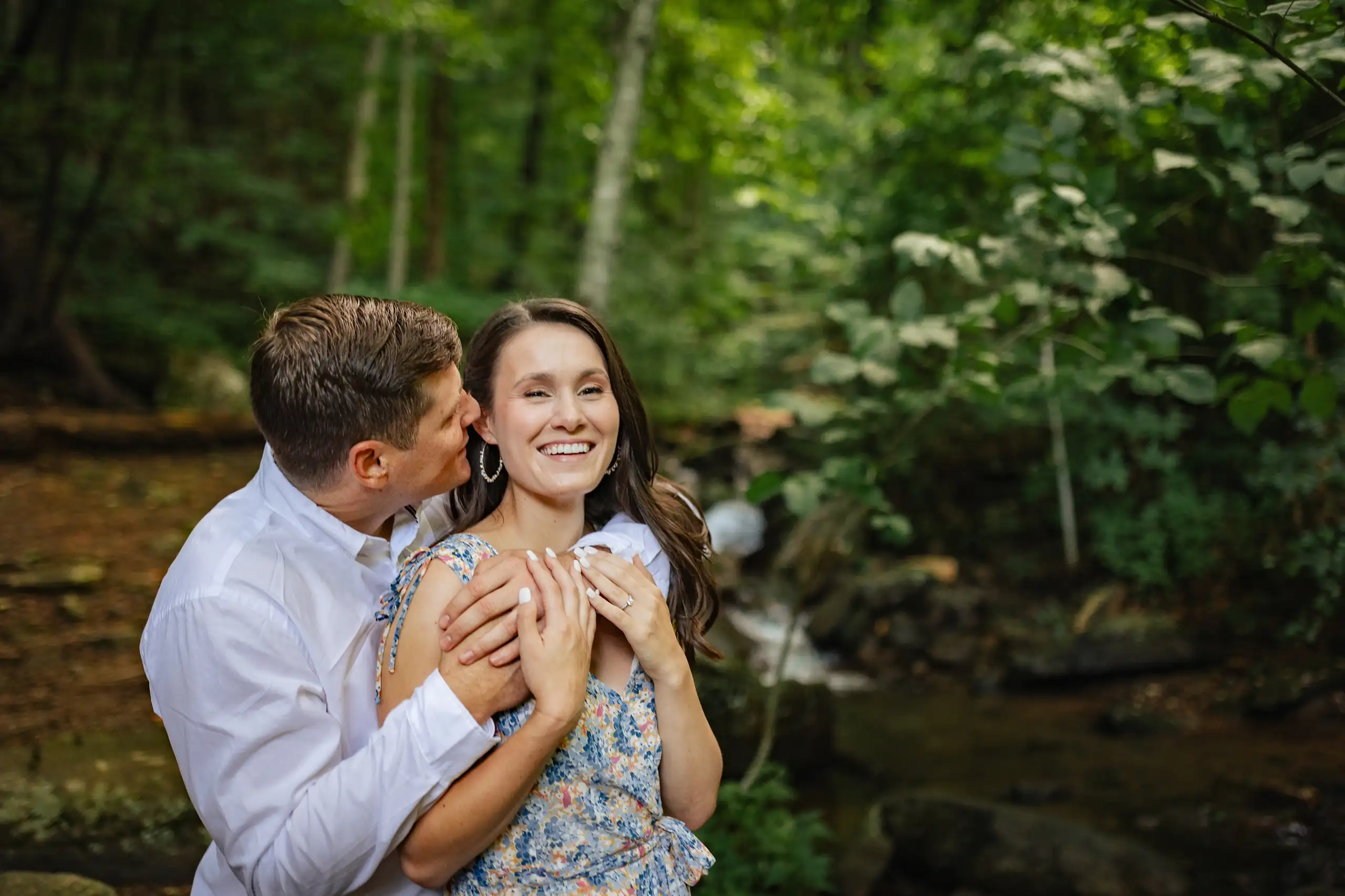 Engagement Portraits: the two of them laughing beside the creek, at their engagement session at Amicalola Falls in Dawsonville, GA