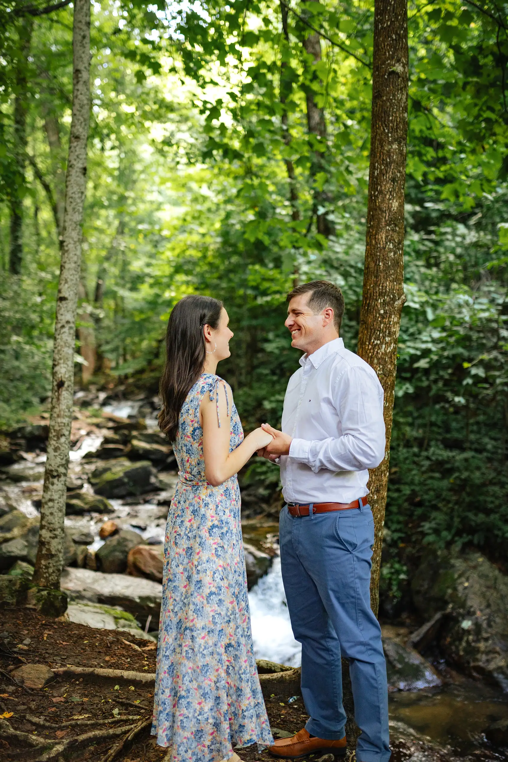 Engagement Portraits: holding hands on the rocks in the woods, at their engagement session at Amicalola Falls in Dawsonville, GA