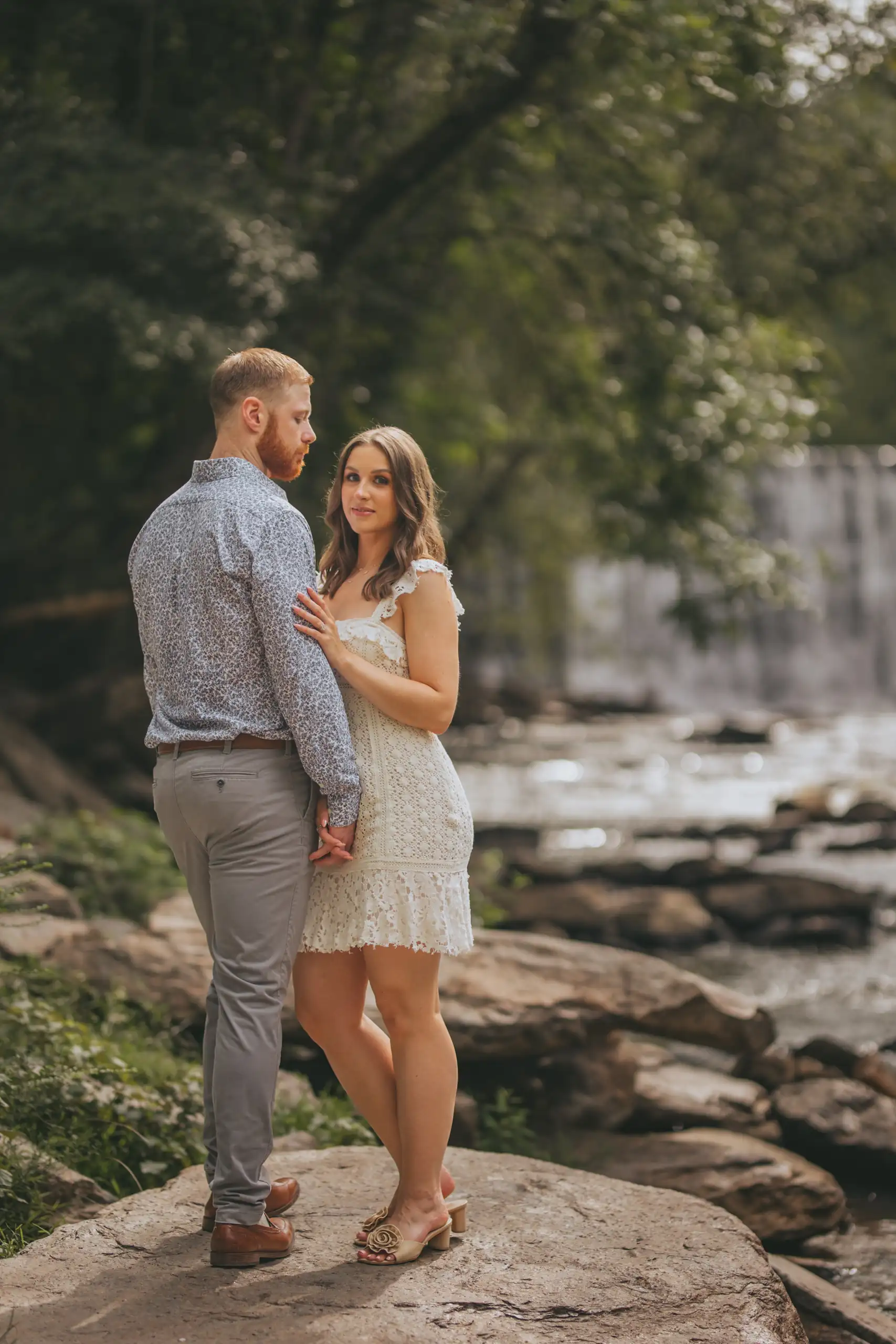 Engagement Portraits: the two of them on the rocks above the creek, during their engagement session at Vickery Creek in Roswell, GA