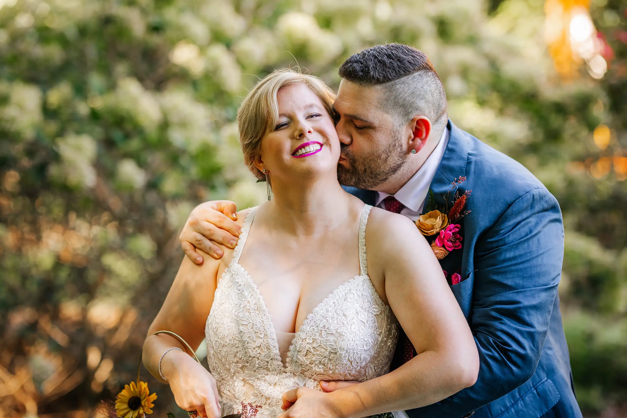 Wedding Formals: the couple with her sunflower bouquet, in a blue suit, at their wedding