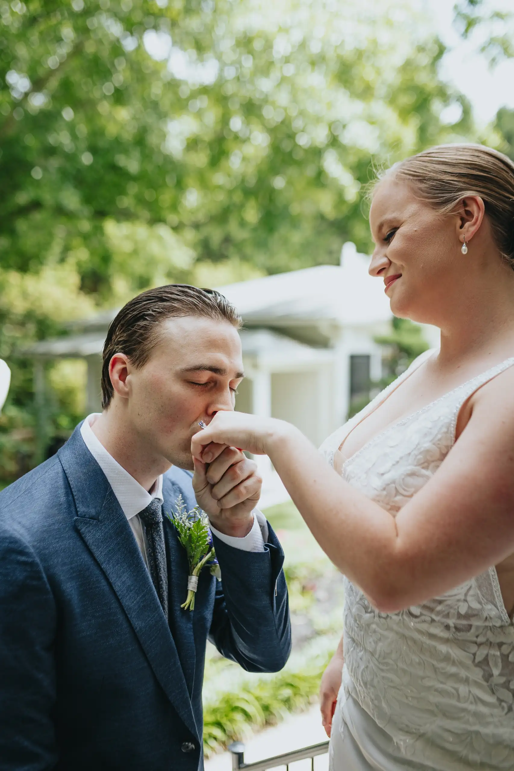 Wedding Formals: him kissing her hand on the terrace, at their wedding at the Wildflower 301 in Greensboro, GA