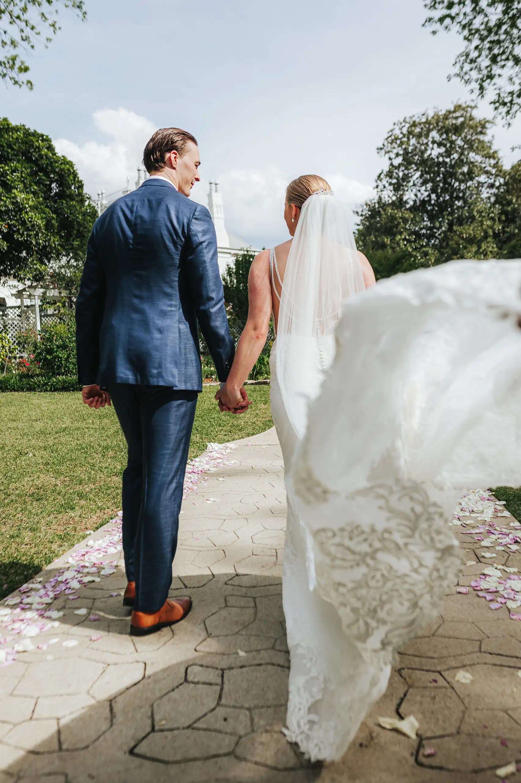 Wedding Formals: walking the garden path with her veil flying, at their wedding at the Wildflower 301 in Greensboro, GA