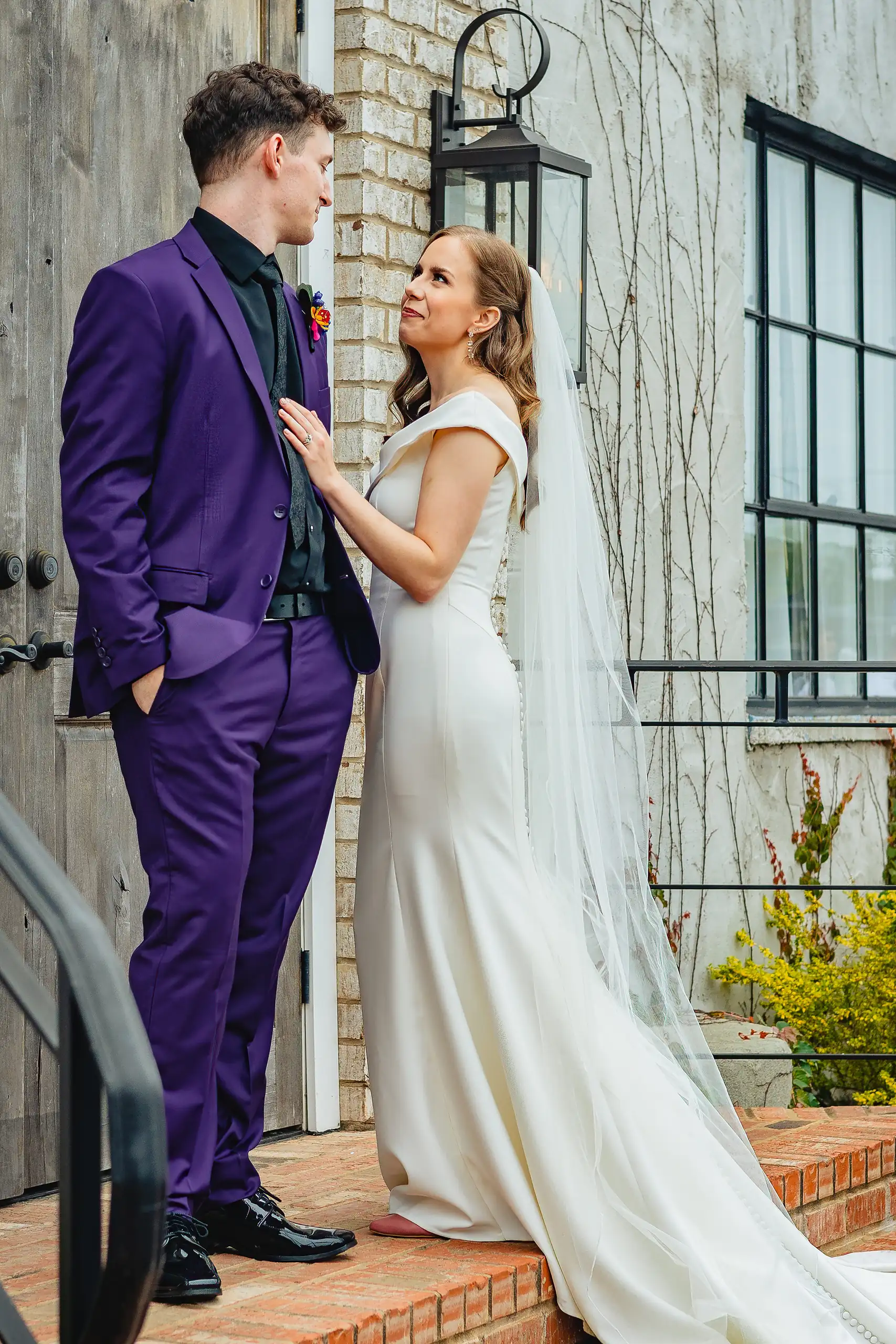 Wedding Formals: the groom in a purple tuxedo on the brick steps, at their wedding at the Foxglove in Marietta, GA