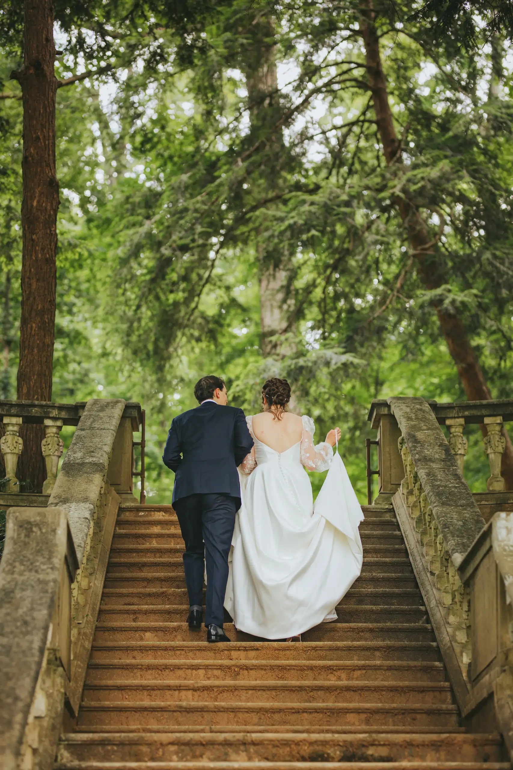 Wedding Formals: the couple climbing the stone steps in the woods, at their wedding at Cator Woolford Gardens in Atlanta, GA