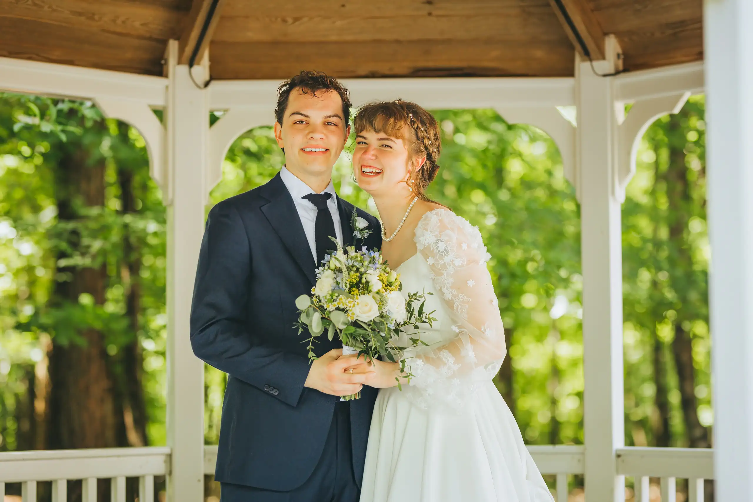 Wedding Formals: the couple together under the white gazebo, at their wedding at Cator Woolford Gardens in Atlanta, GA