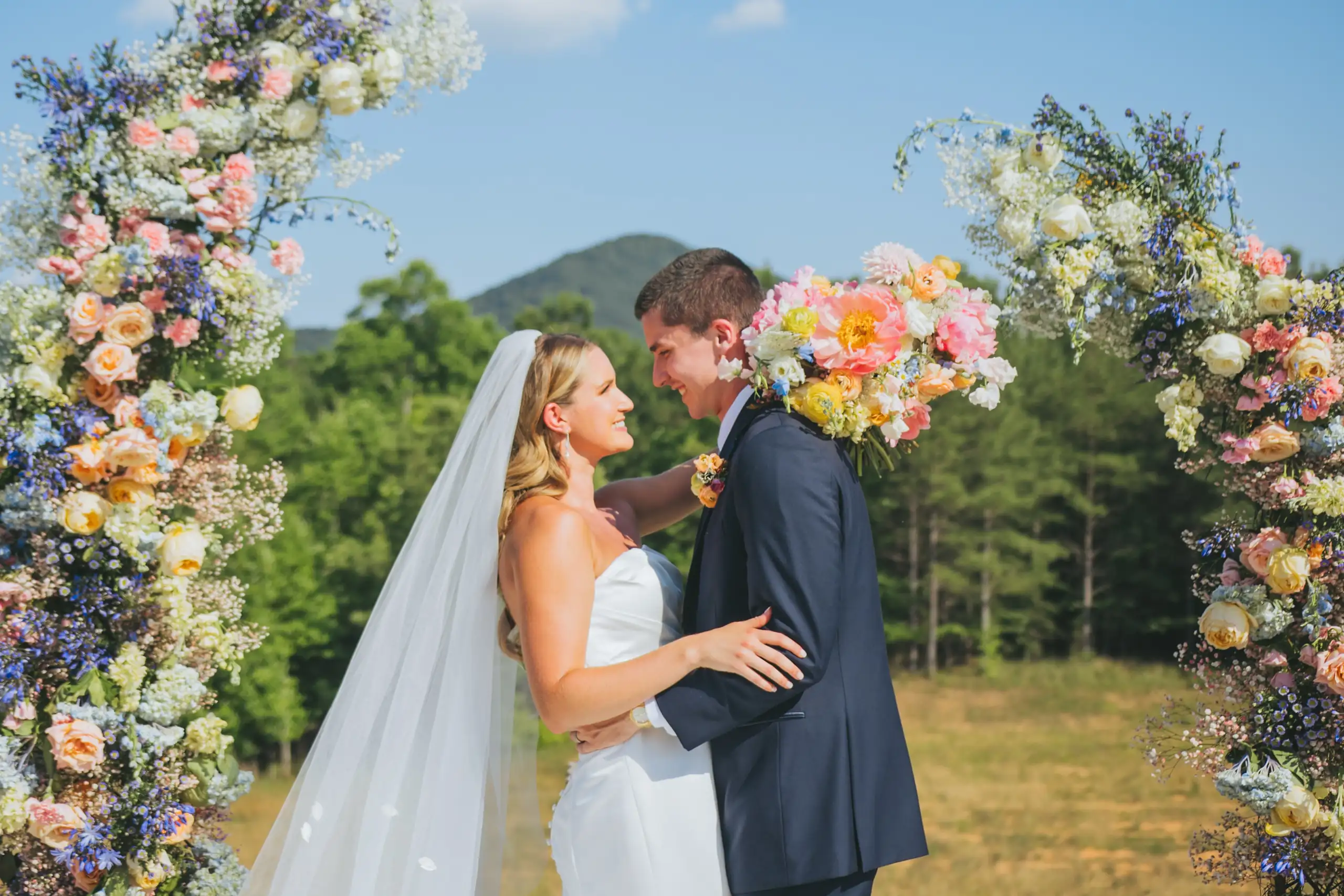 Wedding Formals: the two of them inside the ring of pastel flowers, at their wedding at The Venue at Sharp Mountain in Jasper, GA