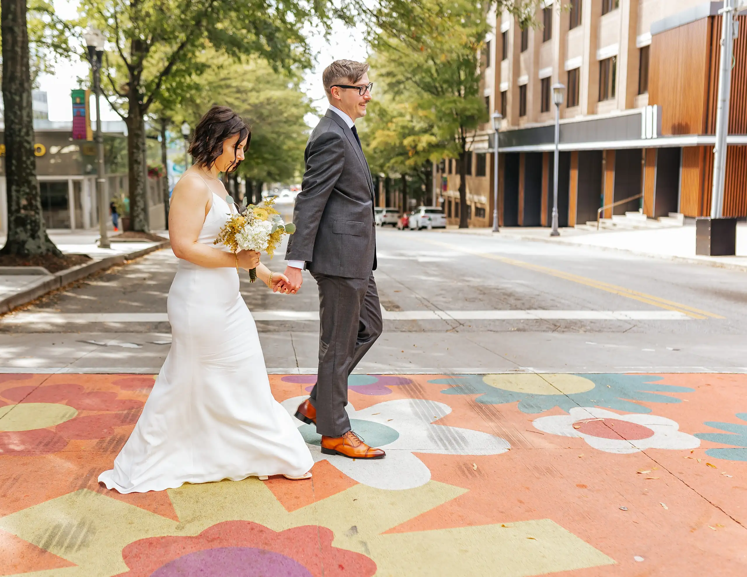Wedding Formals: the two of them on the painted crossing in the street, at their wedding at the White Bull in Decatur, GA