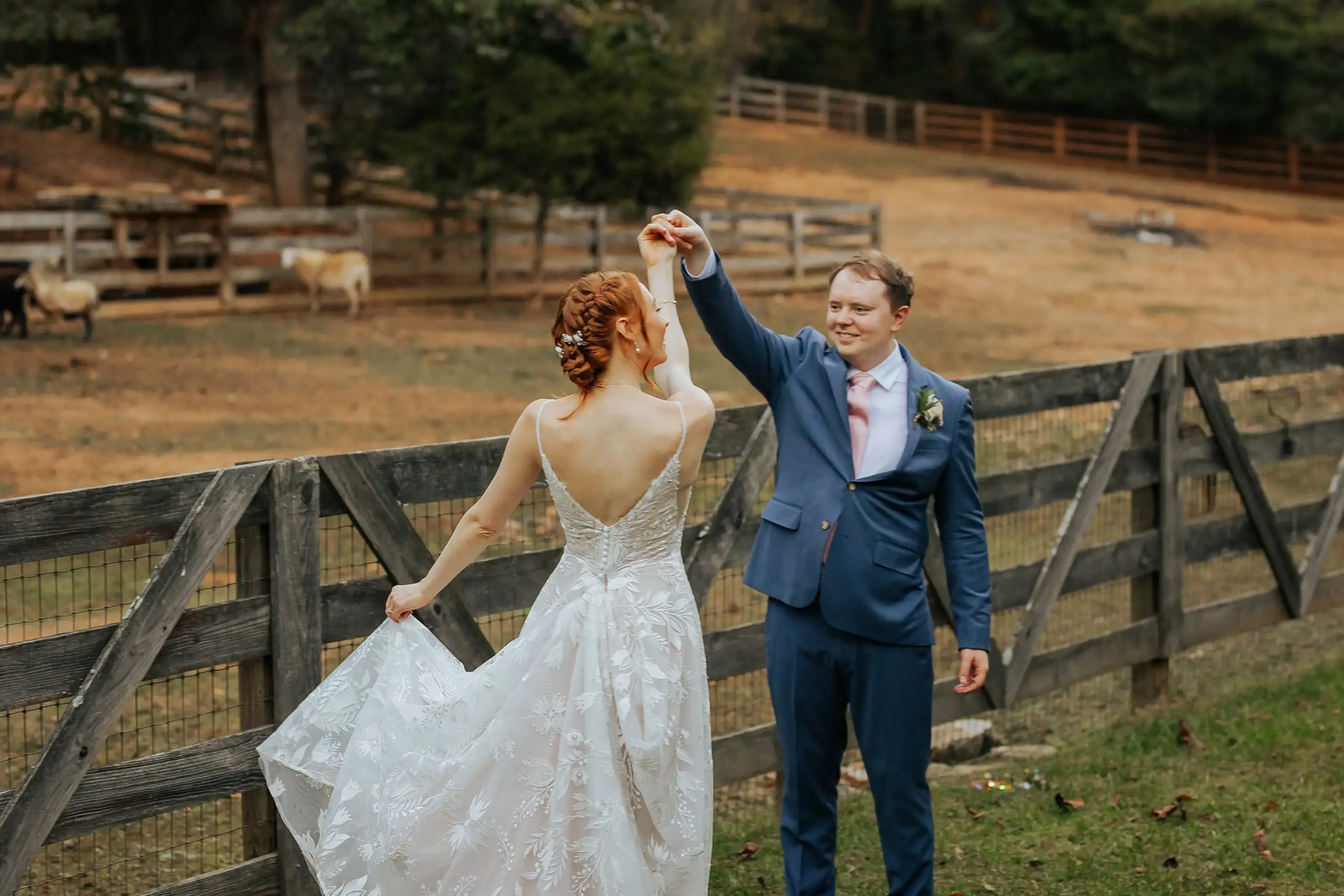 Wedding Formals: him turning her by the paddock fence, at their wedding at Three Birches in Alpharetta, GA