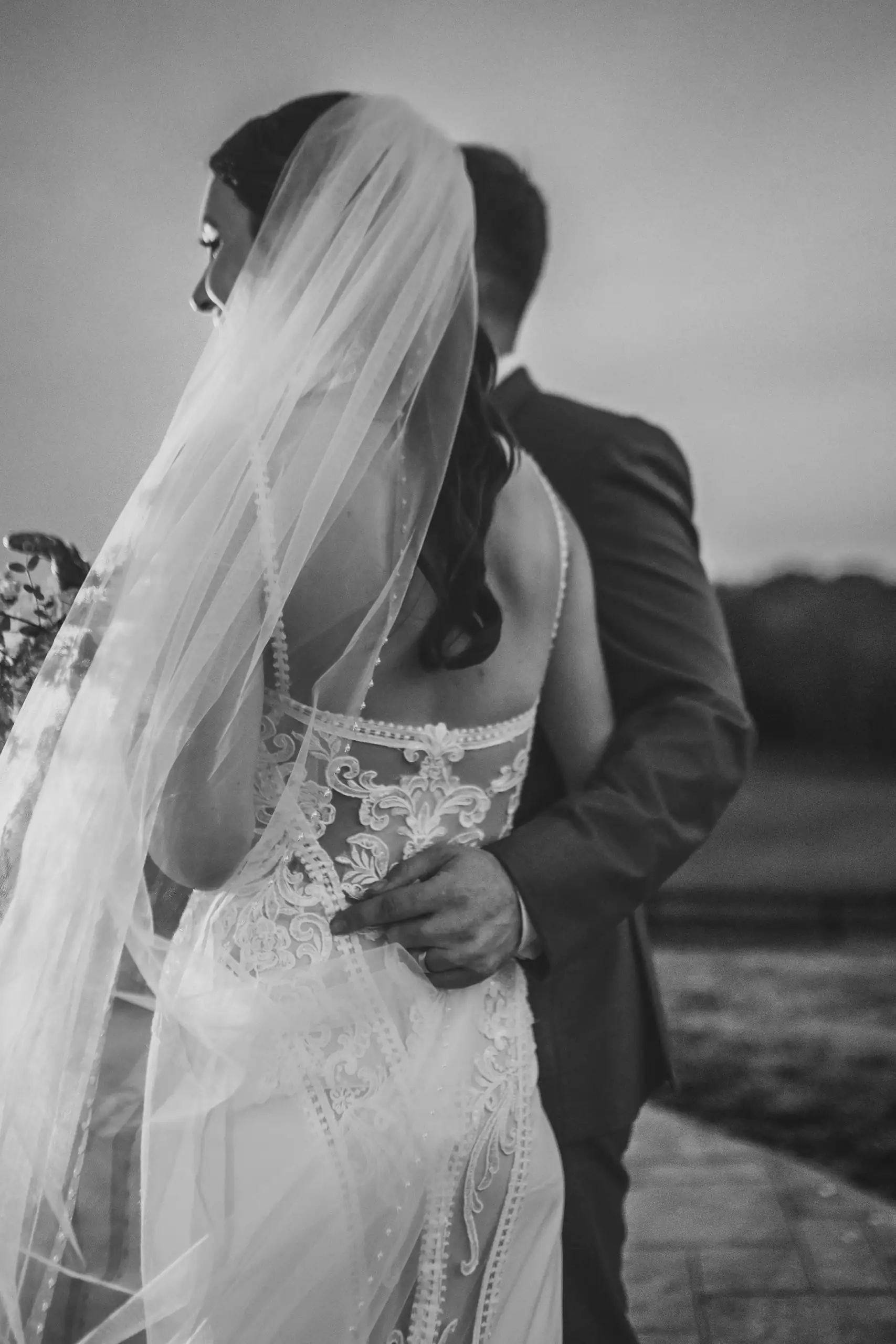 Bridal Portraits: the bride under her veil, in black and white, at their wedding at Swan Lake Overlook in Dawsonville, GA