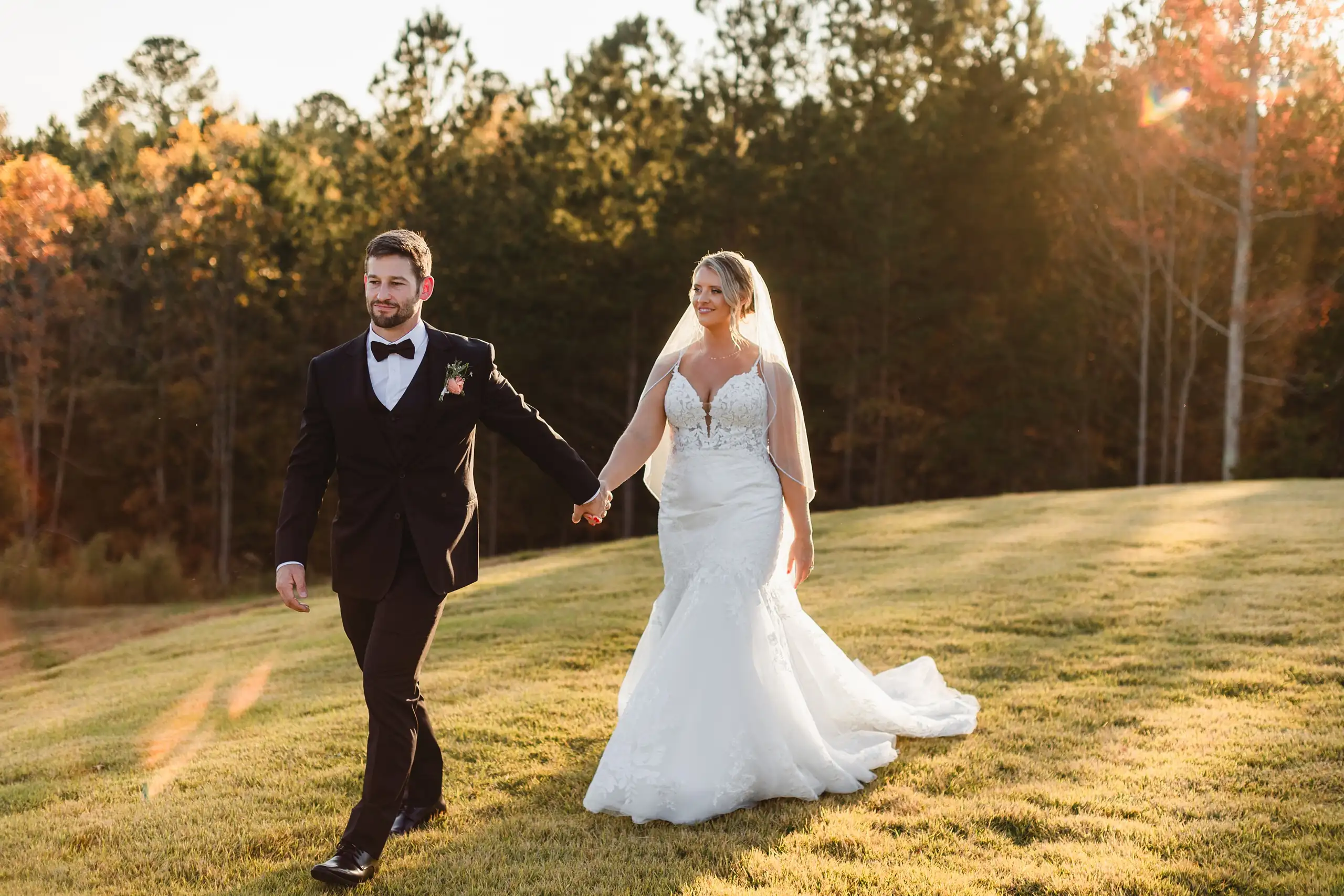 Wedding Formals: the two of them walking the lawn as the sun drops, at their wedding at The Venue at Sharp Mountain in Jasper, GA