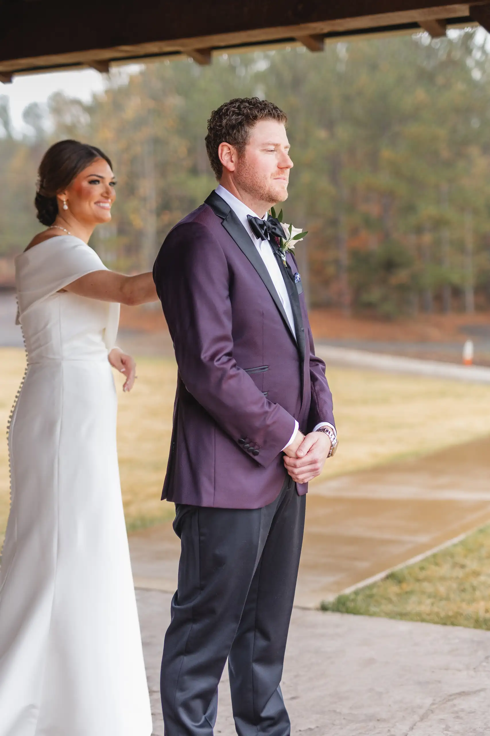 First Look: her hand on his shoulder as he waits, facing away, before their wedding at The Venue at Sharp Mountain in Jasper, GA