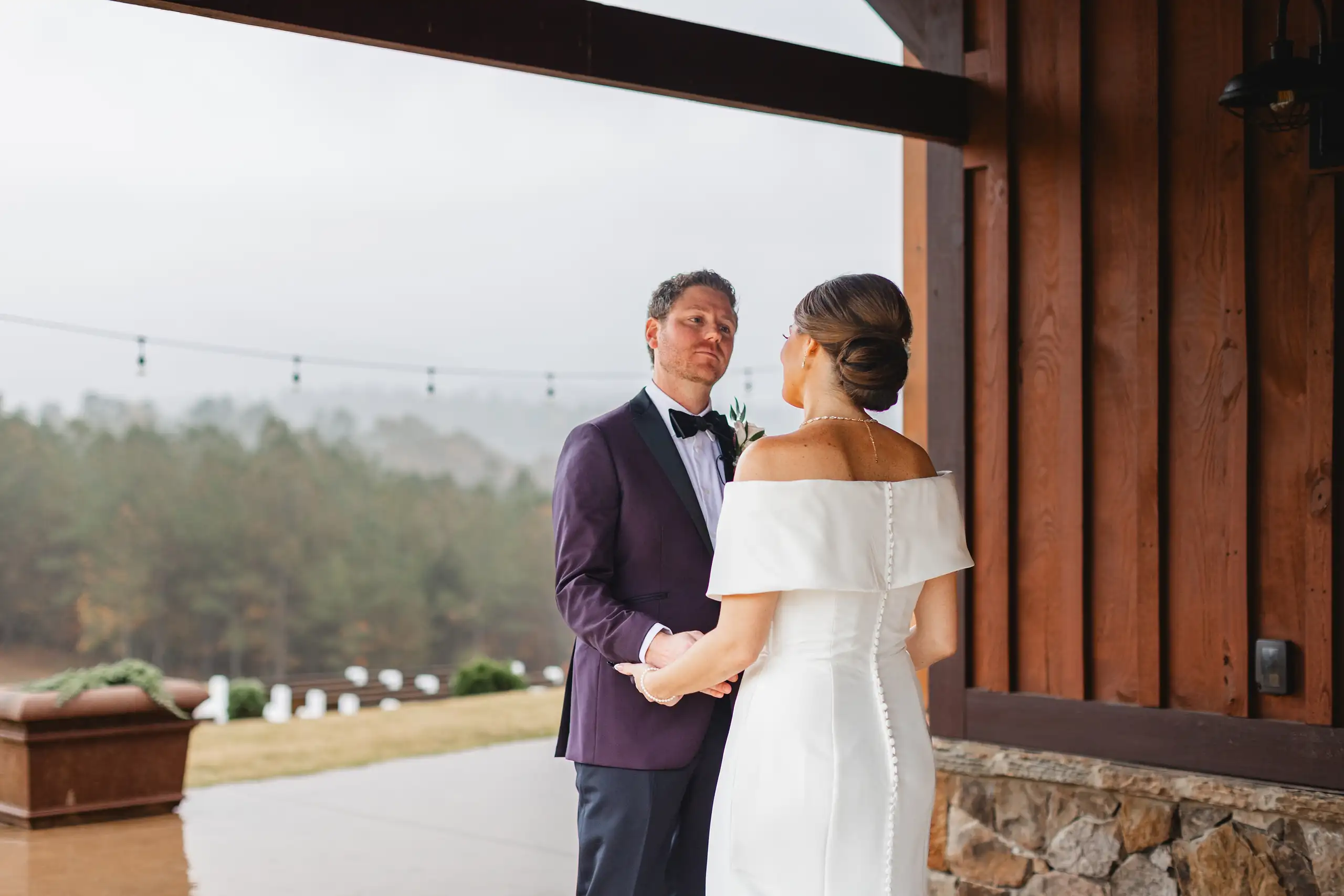First Look: the couple holding each other after he turns round, before their wedding at The Venue at Sharp Mountain in Jasper, GA