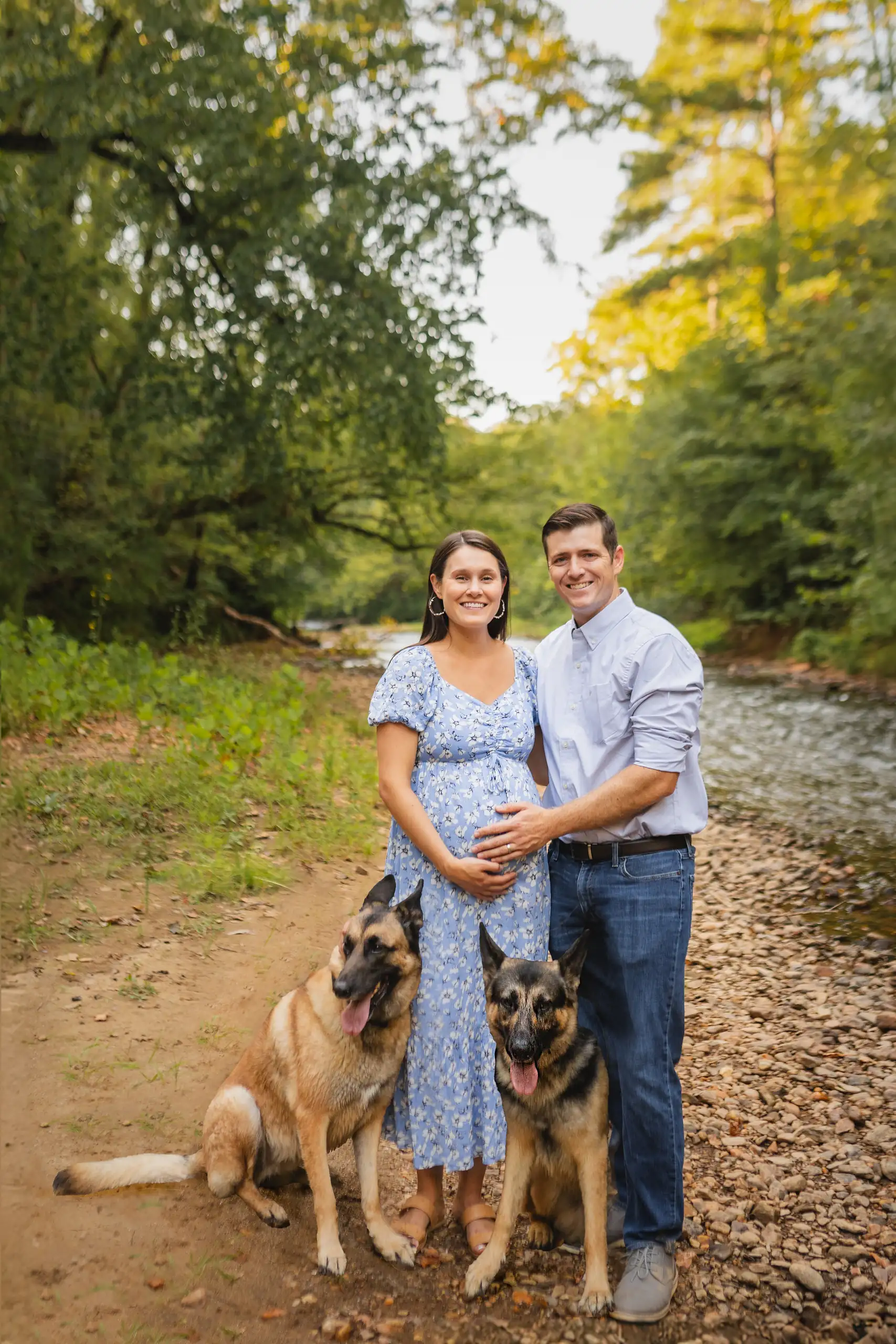 Maternity Portraits: the two of them on the track with their two dogs, at their maternity session in Ball Ground, GA