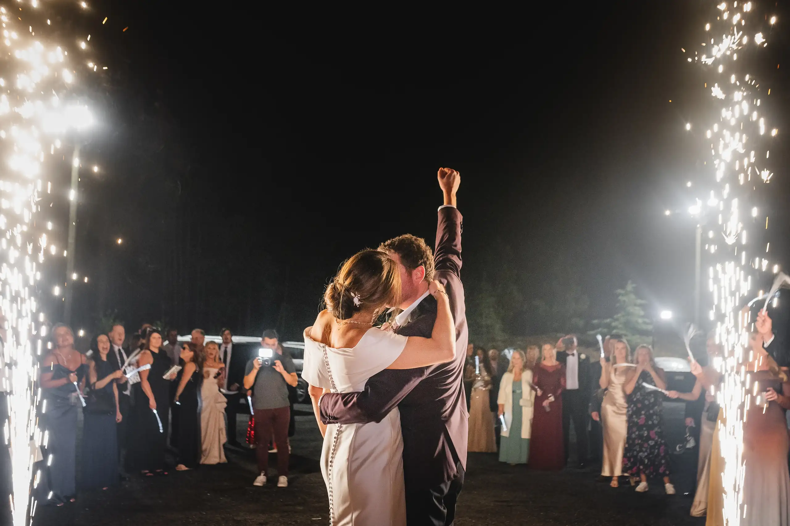 Send-Off: the exit through two rows of cold sparks, at their wedding at The Venue at Sharp Mountain in Jasper, GA