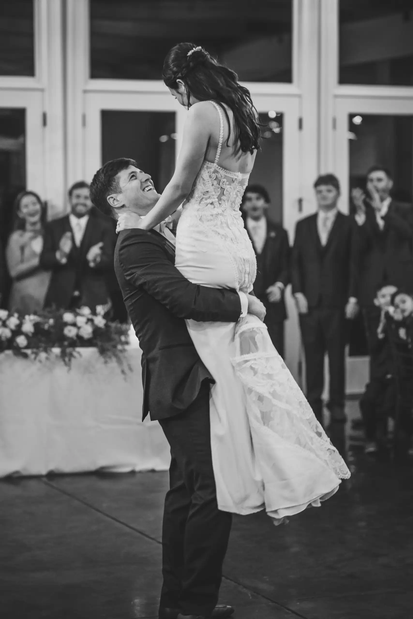 Wedding Reception: the groom lifting her in front of the guests, at their wedding at Swan Lake Overlook in Dawsonville, GA