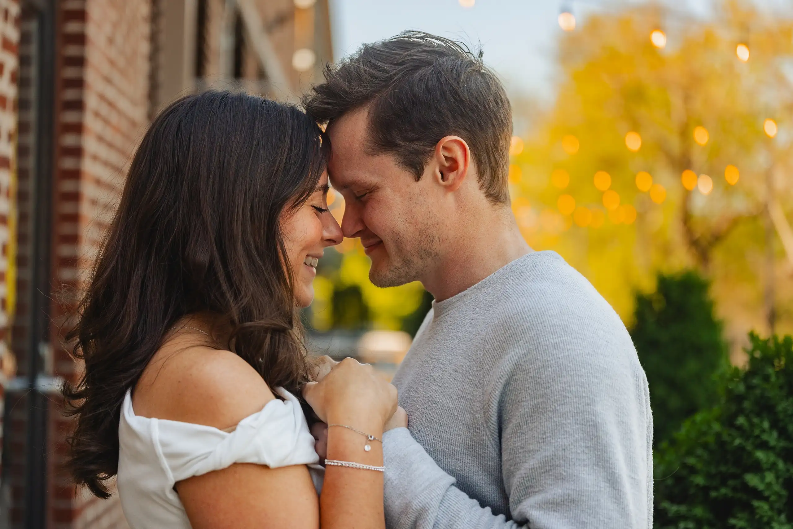 Engagement Portraits: foreheads together in the evening light, during their engagement session at Westside Provisions in Atlanta, GA