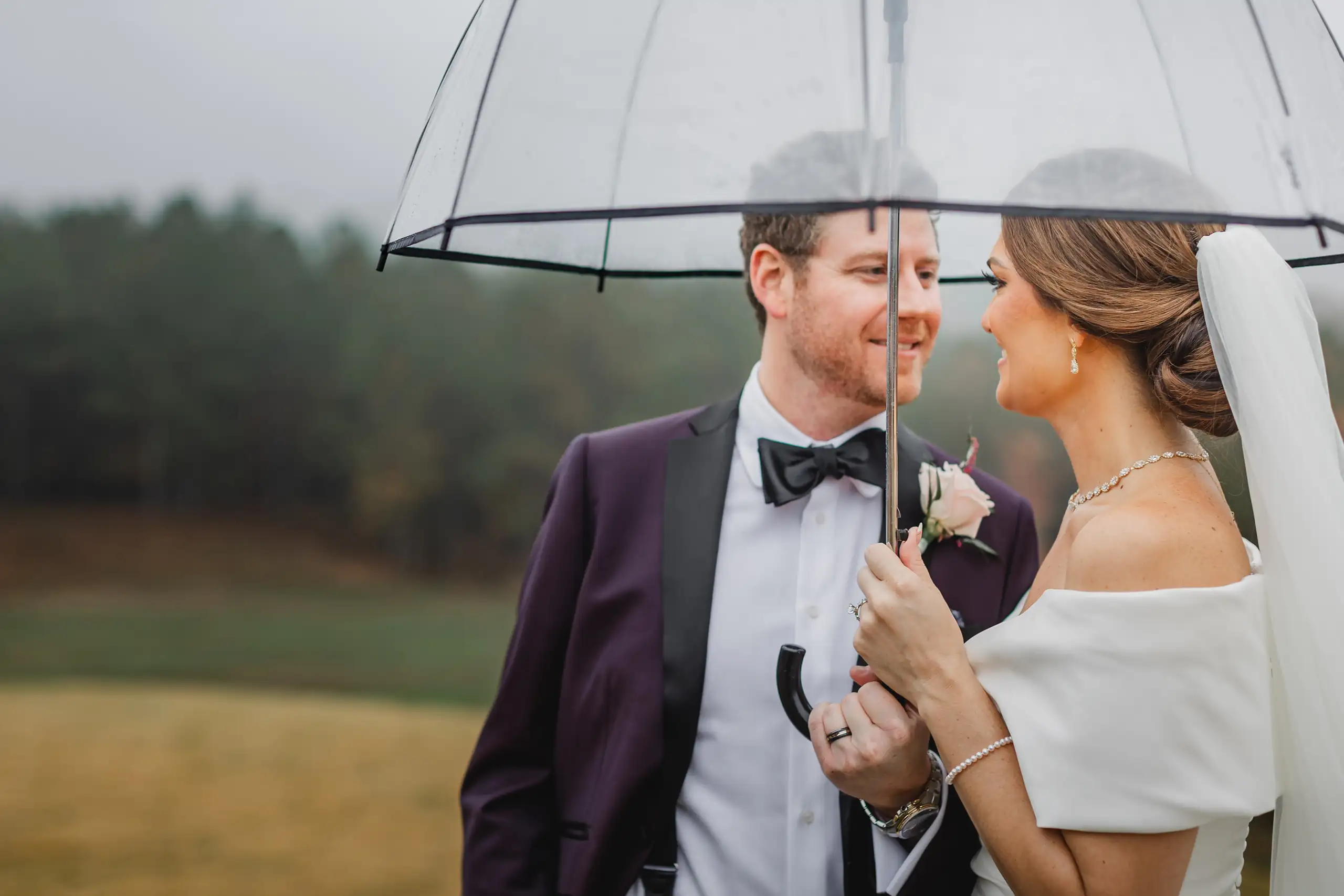 Wedding Formals: the couple under a clear umbrella in the mist, at their wedding at The Venue at Sharp Mountain in Jasper, GA