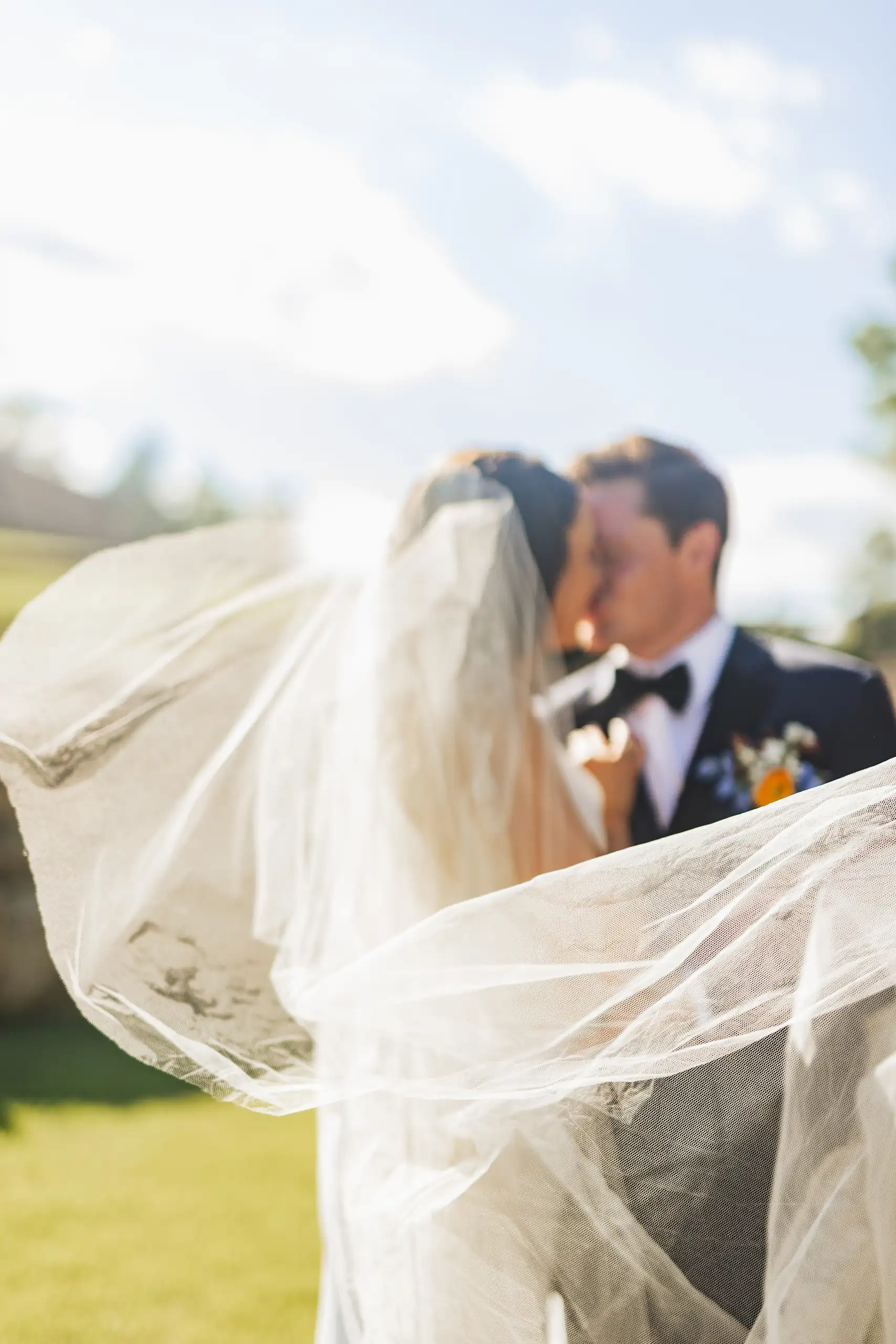Wedding Formals: the two of them behind her veil in the wind, at their wedding at The Venue at Sharp Mountain in Jasper, GA