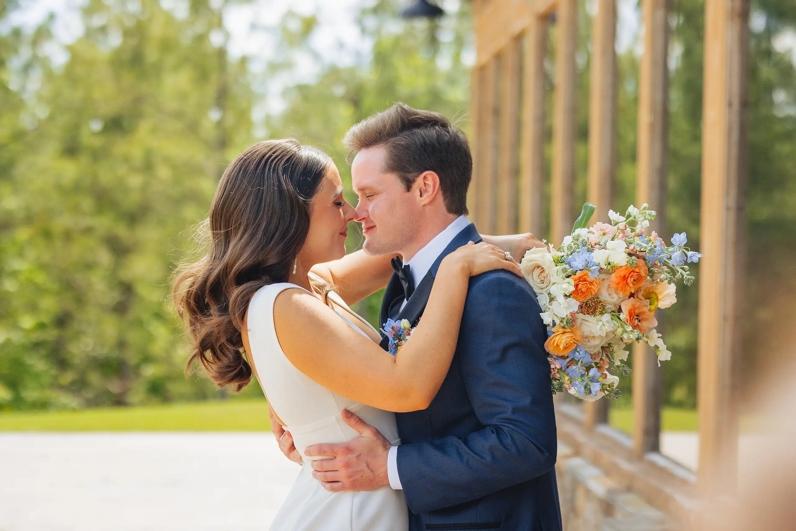 Wedding Formals: the two of them close with her bouquet between them, at their wedding at The Venue at Sharp Mountain in Jasper, GA