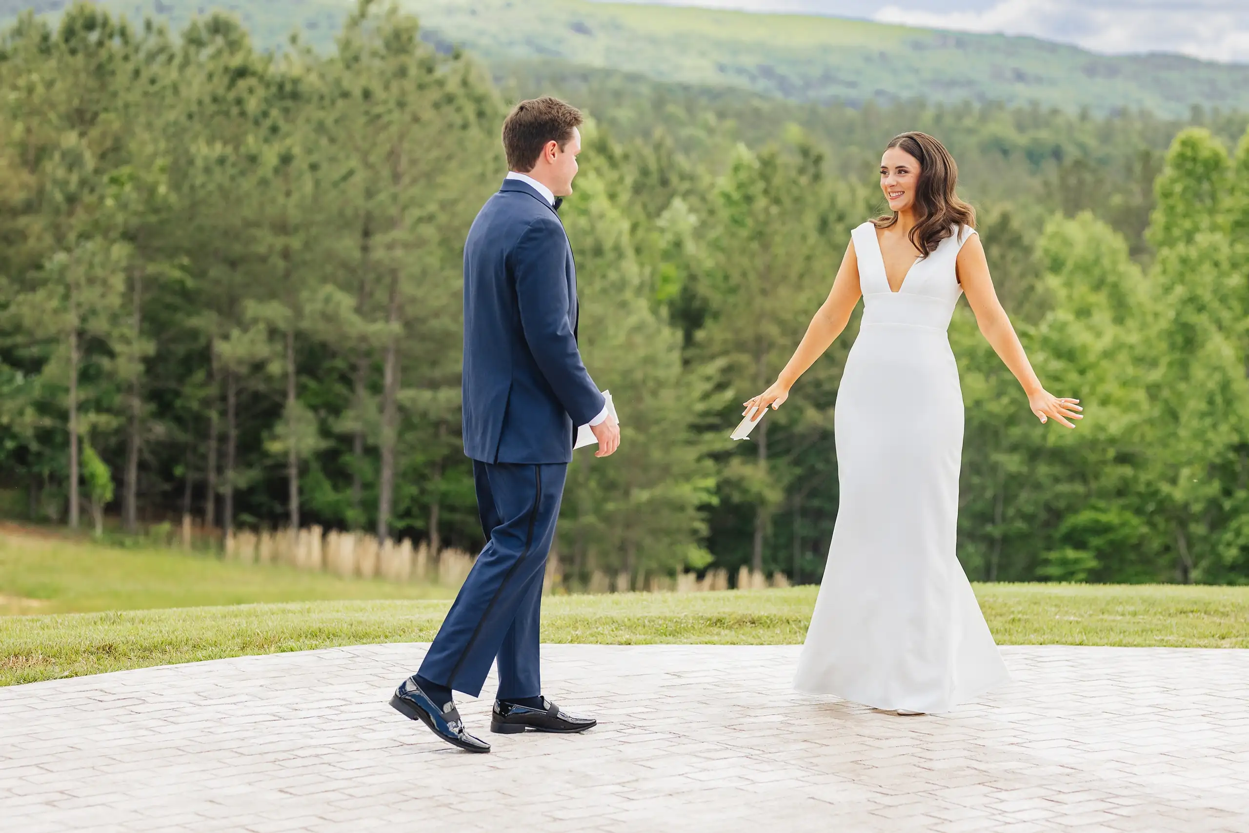 First Look: the bride walking up behind him on the terrace, before their wedding at The Venue at Sharp Mountain in Jasper, GA
