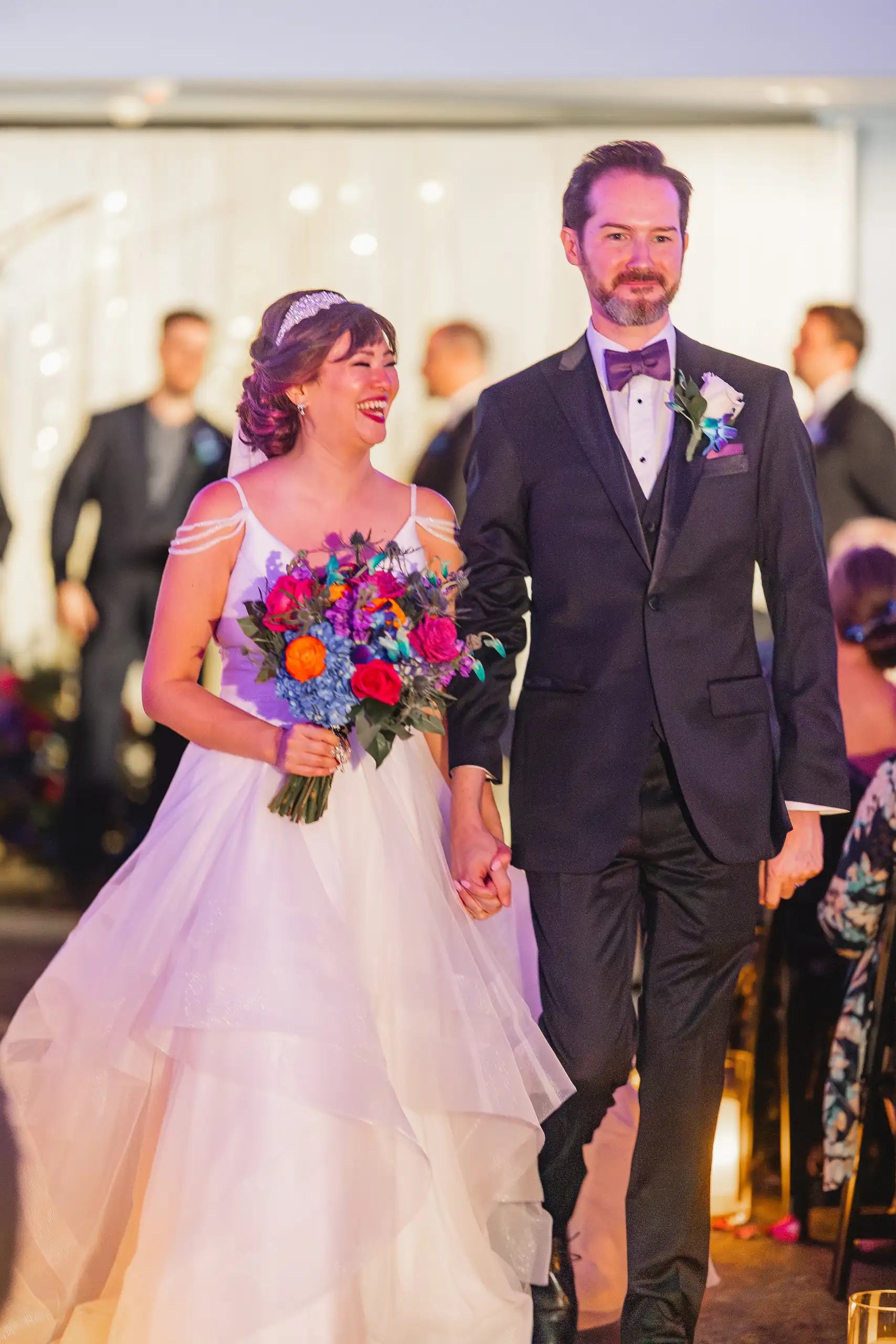Recessional: the couple coming back up the aisle together, at their wedding at Fernbank Museum in Atlanta, GA