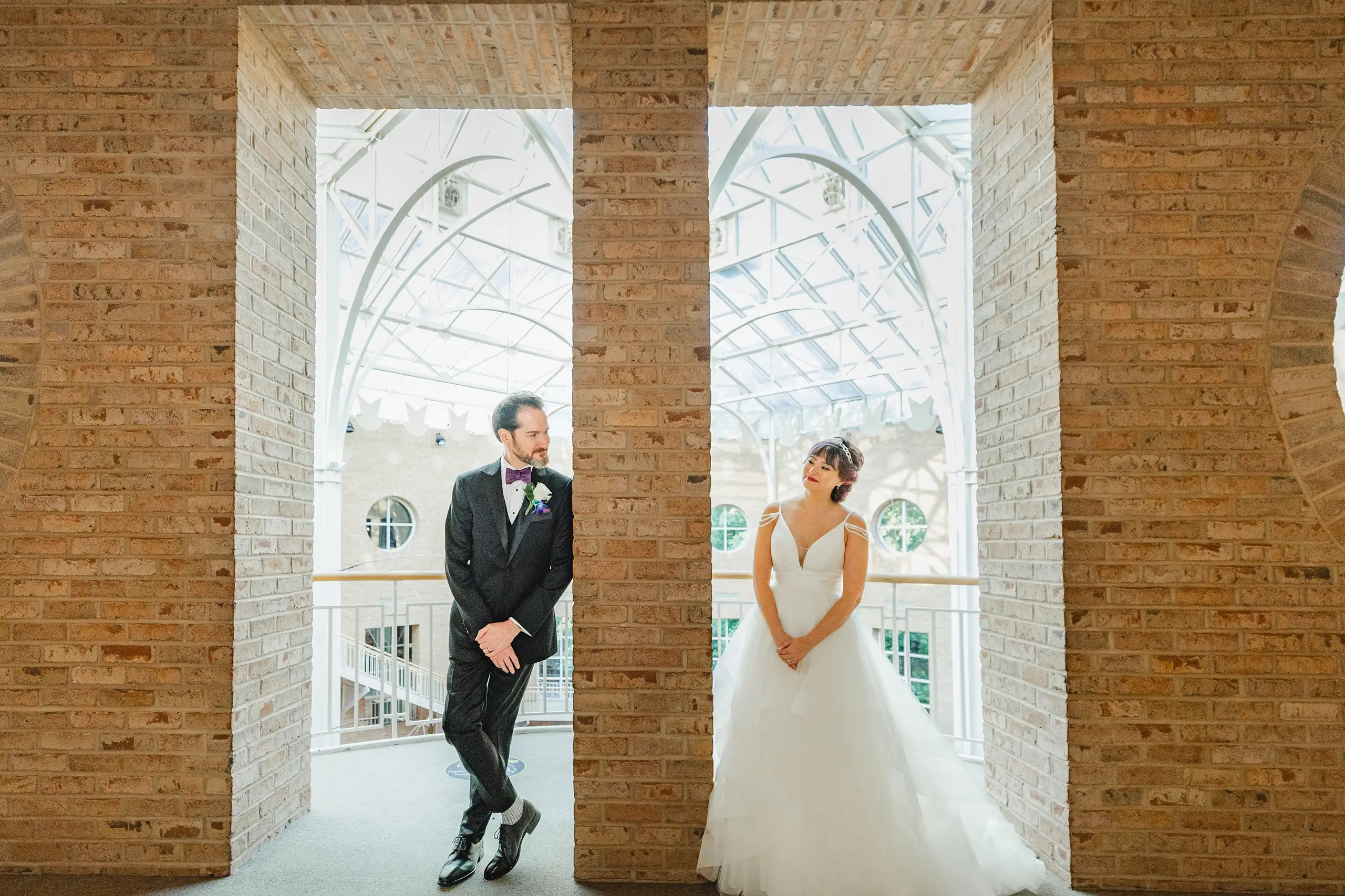 Wedding Formals: the two of them framed in the brick archways, at their wedding at Fernbank Museum in Atlanta, GA