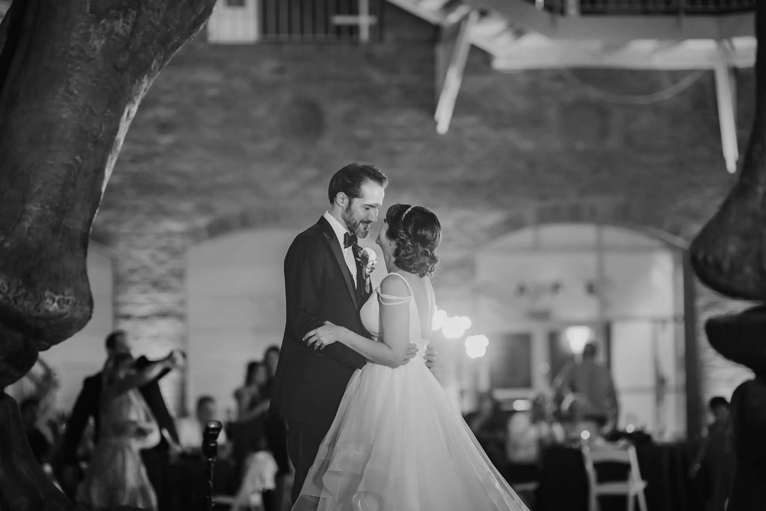 First Dance: dancing close beneath the ribs of the skeleton, at their wedding at Fernbank Museum in Atlanta, GA