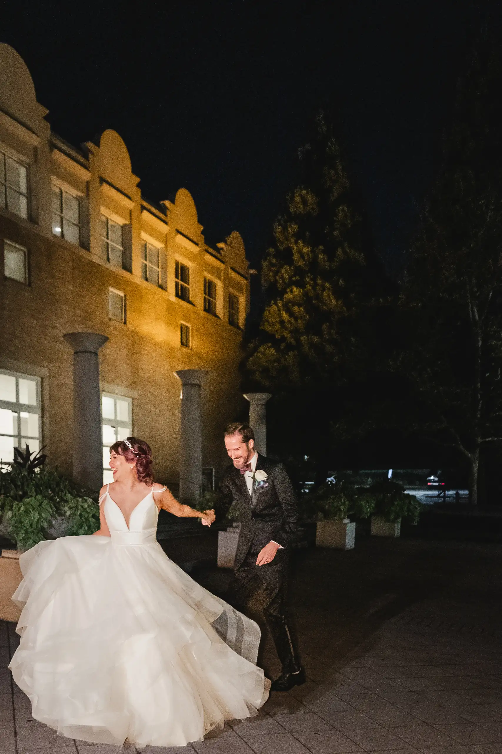 Wedding Formals: the couple outside the museum after dark, at their wedding at Fernbank Museum in Atlanta, GA