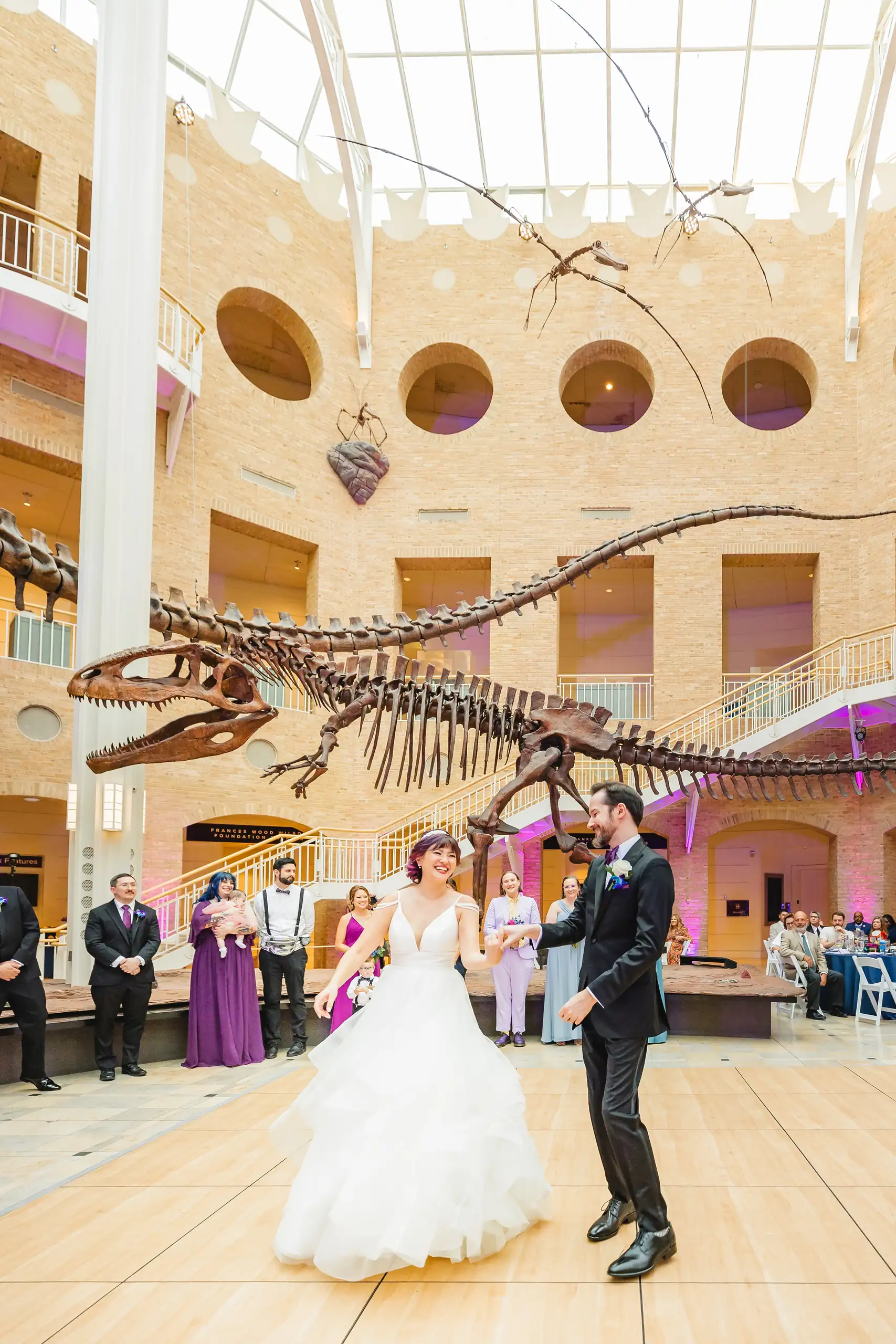 First Dance: their first dance under the skeletons in the Great Hall, at their wedding at Fernbank Museum in Atlanta, GA
