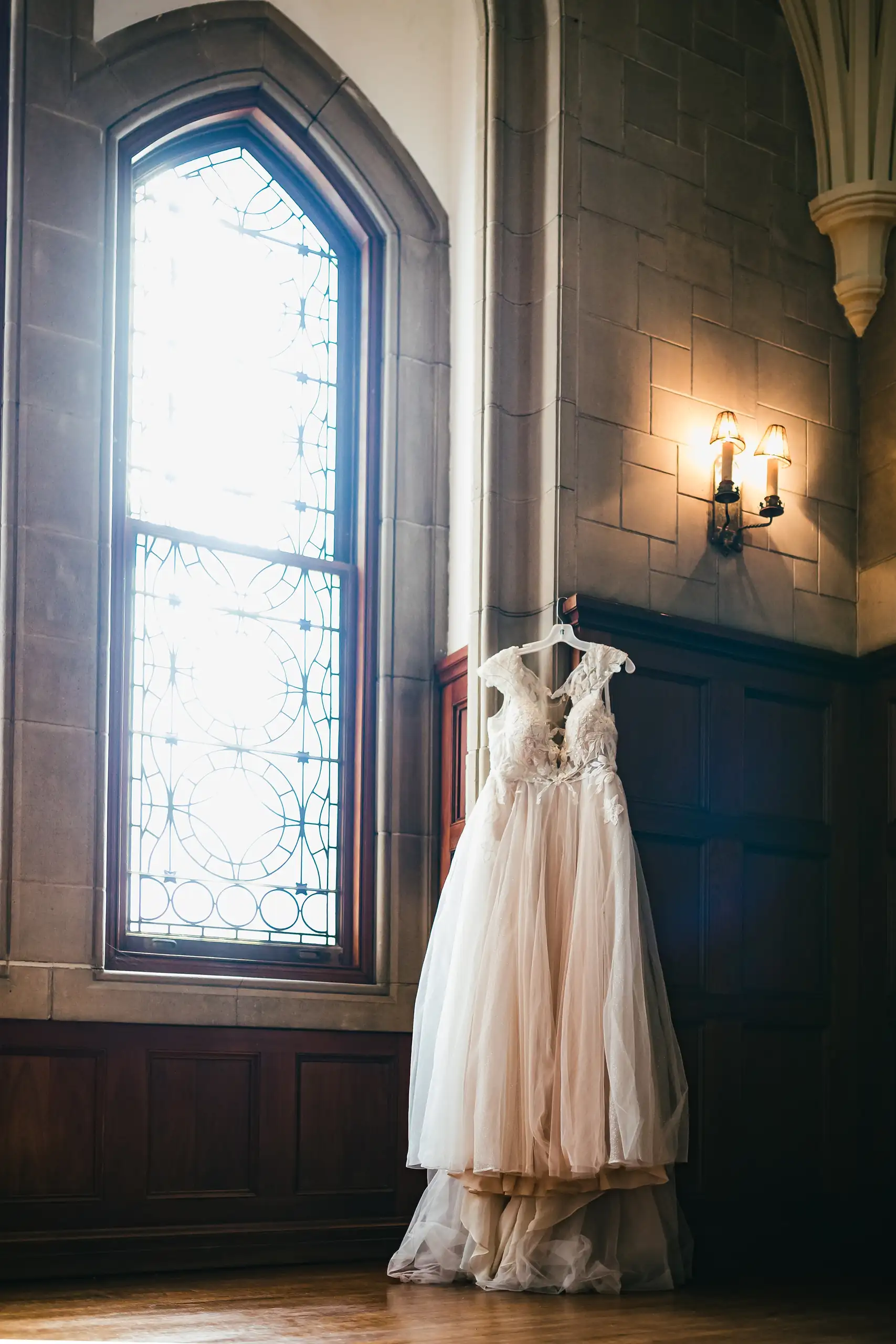 Wedding Details: the gown hanging in the gothic window, at a wedding at Callanwolde Fine Arts Center in Atlanta, GA