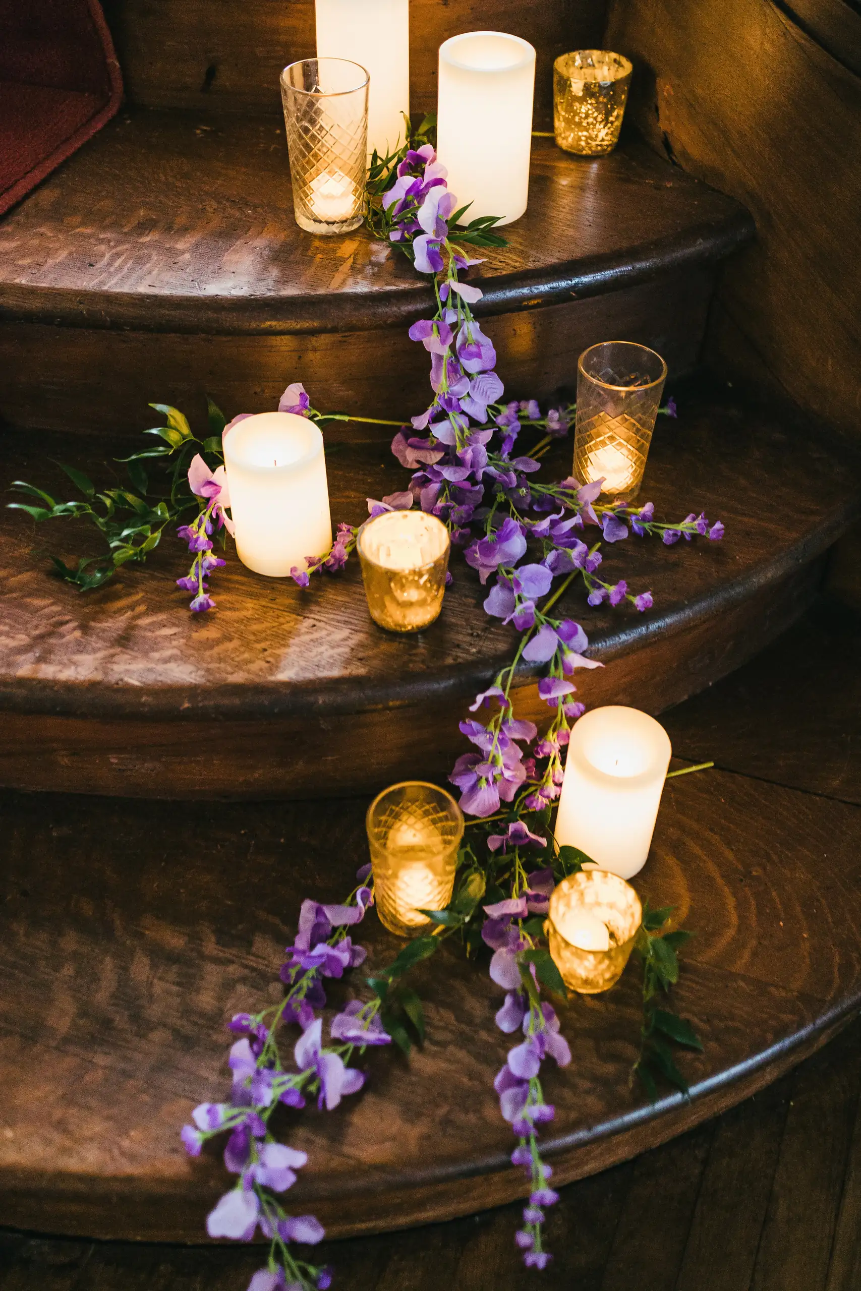 Reception Details: candles and purple orchids running down the wooden stairs, at a wedding at Callanwolde Fine Arts Center in Atlanta, GA