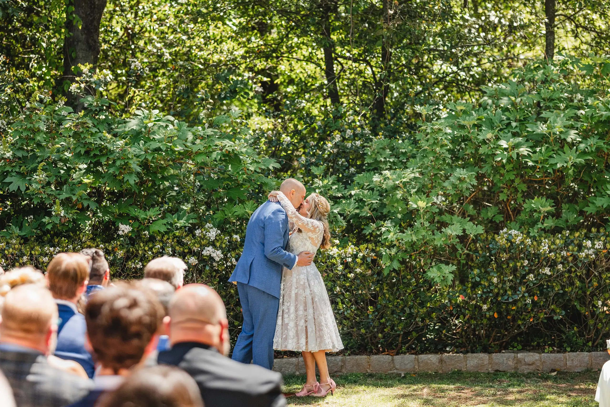 Wedding Ceremony: the first kiss at the outdoor ceremony, at their wedding at Callanwolde Fine Arts Center in Atlanta, GA