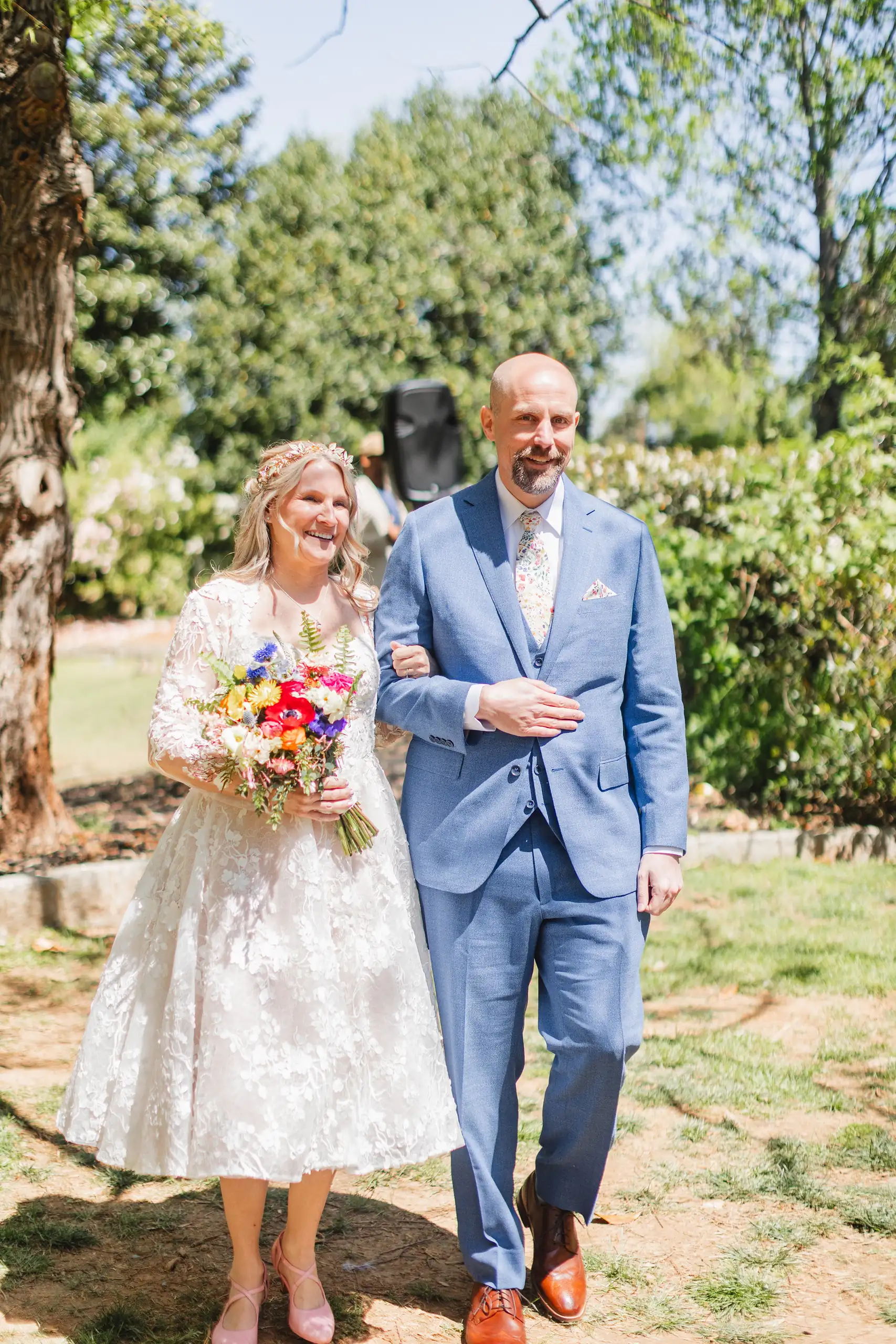 Wedding Formals: the couple walking the lawn with her bouquet, at their wedding at Callanwolde Fine Arts Center in Atlanta, GA