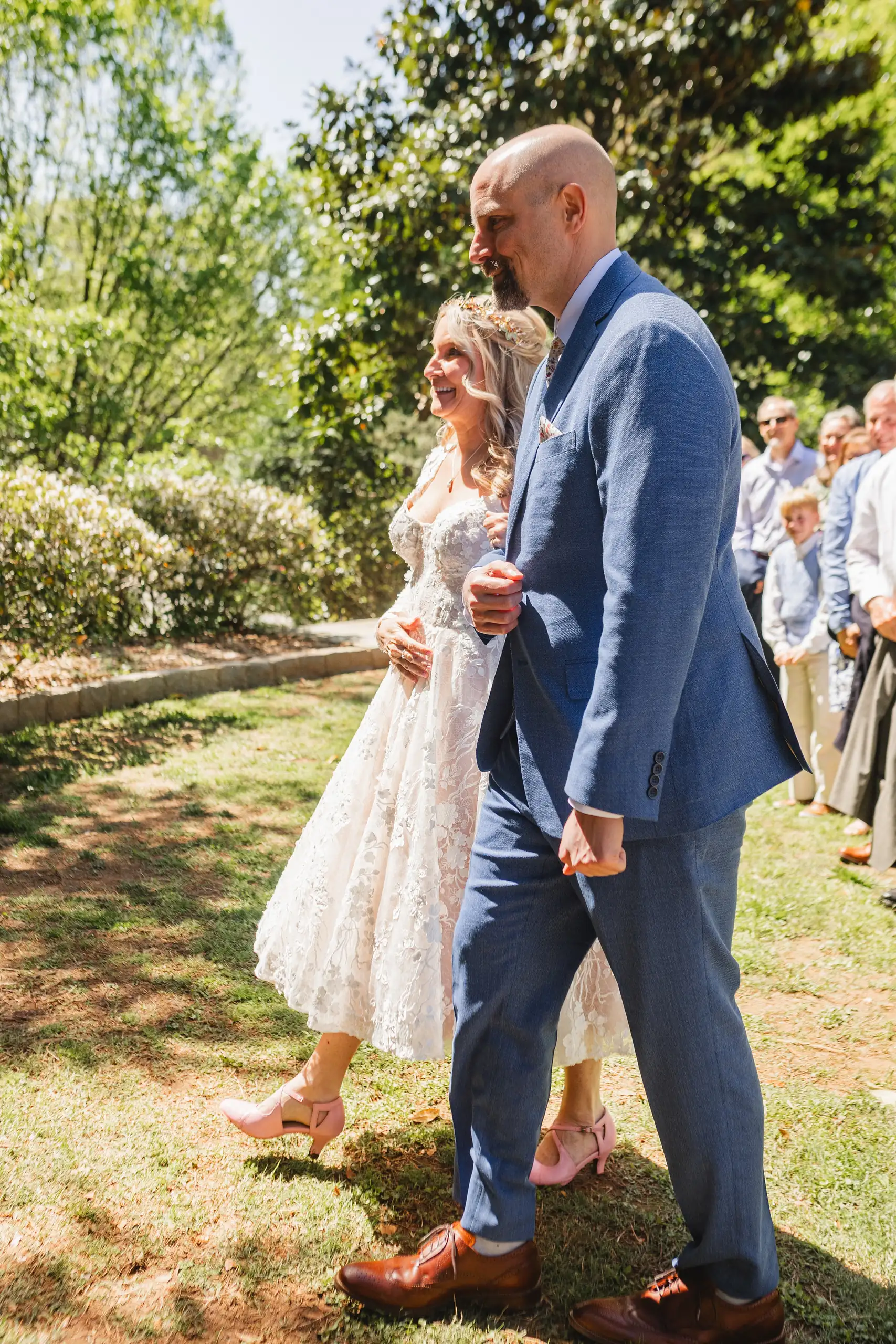 Processional: the couple walking in as the guests stand, at their wedding at Callanwolde Fine Arts Center in Atlanta, GA