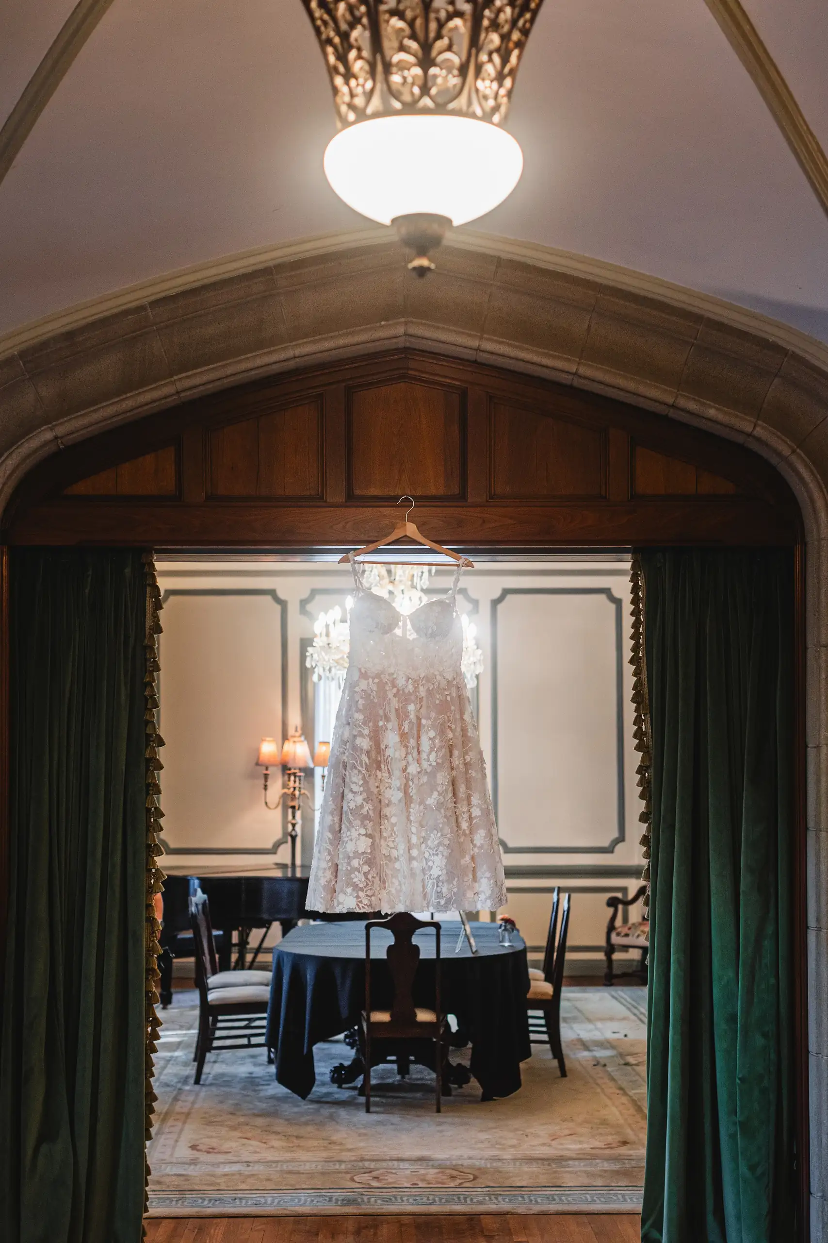 Wedding Details: the gown hanging in a green-draped doorway, at a wedding at Callanwolde Fine Arts Center in Atlanta, GA