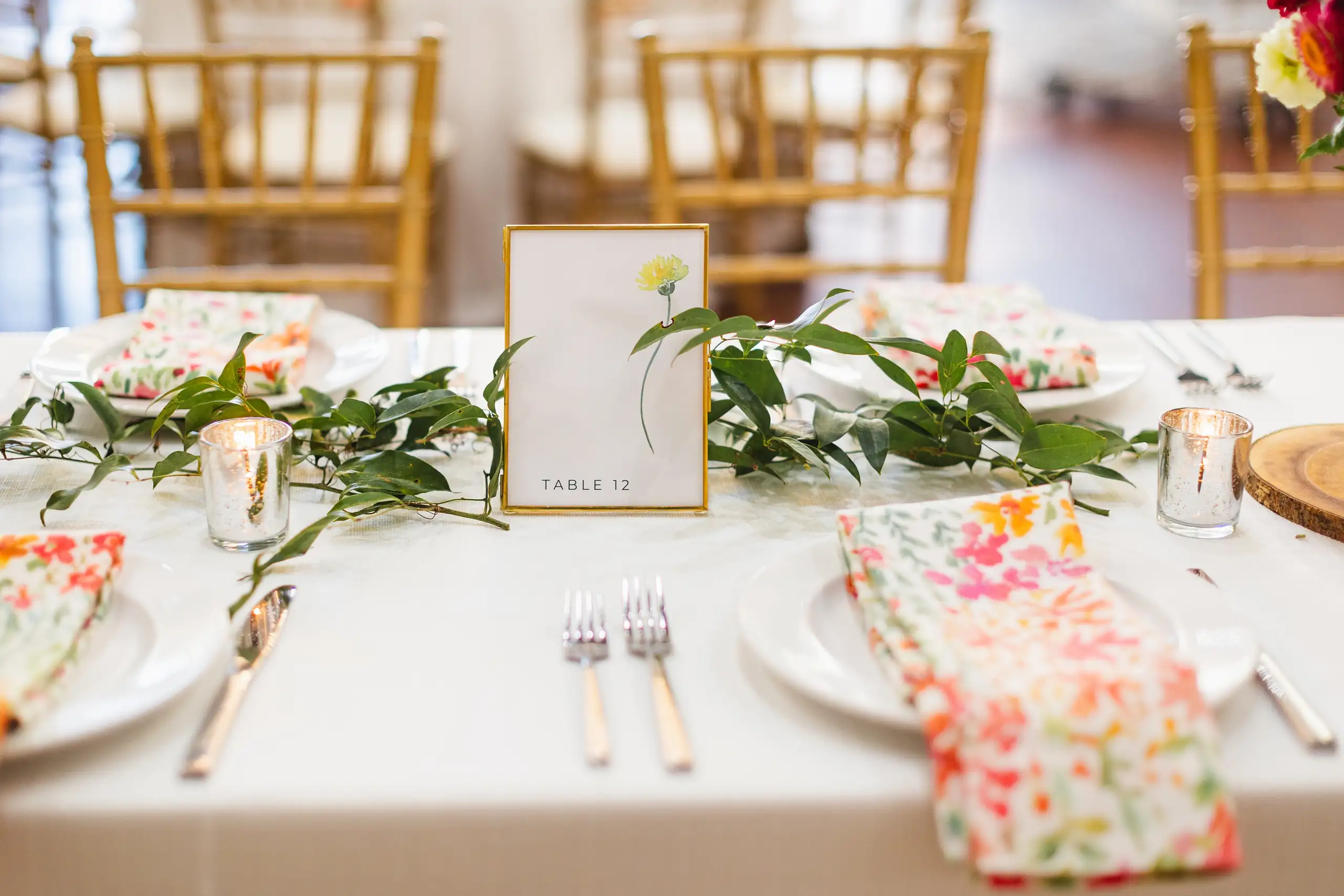 Reception Details: the table with its greenery runner and floral napkins, at their wedding at Callanwolde Fine Arts Center in Atlanta, GA