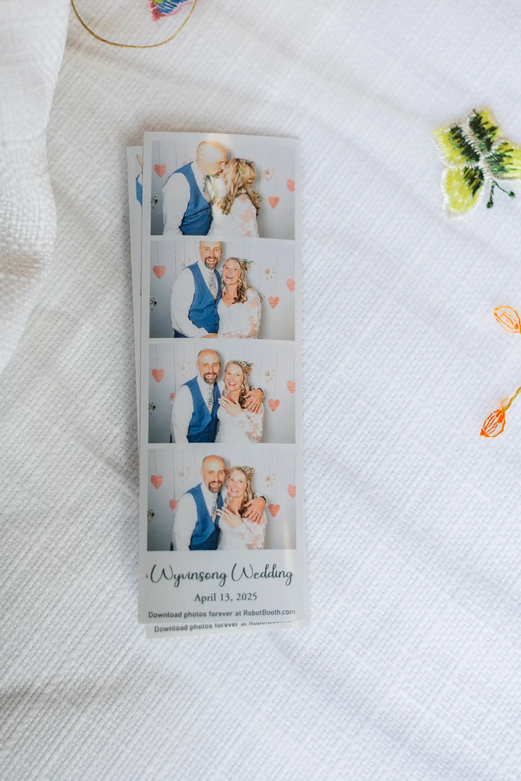 Reception Details: a photo booth strip among pressed flowers, at their wedding at Callanwolde Fine Arts Center in Atlanta, GA