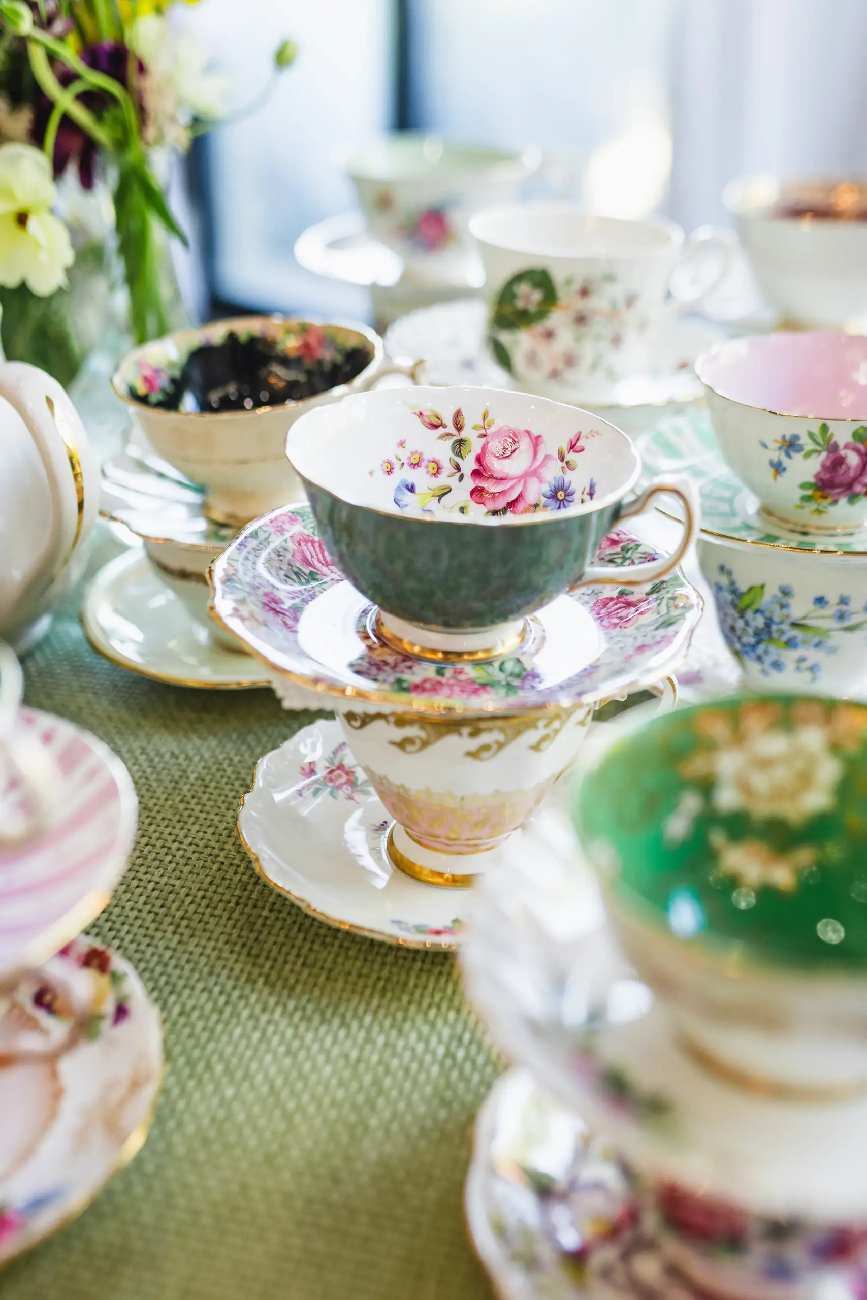 Reception Details: vintage floral teacups stacked on their saucers, at their wedding at Callanwolde Fine Arts Center in Atlanta, GA