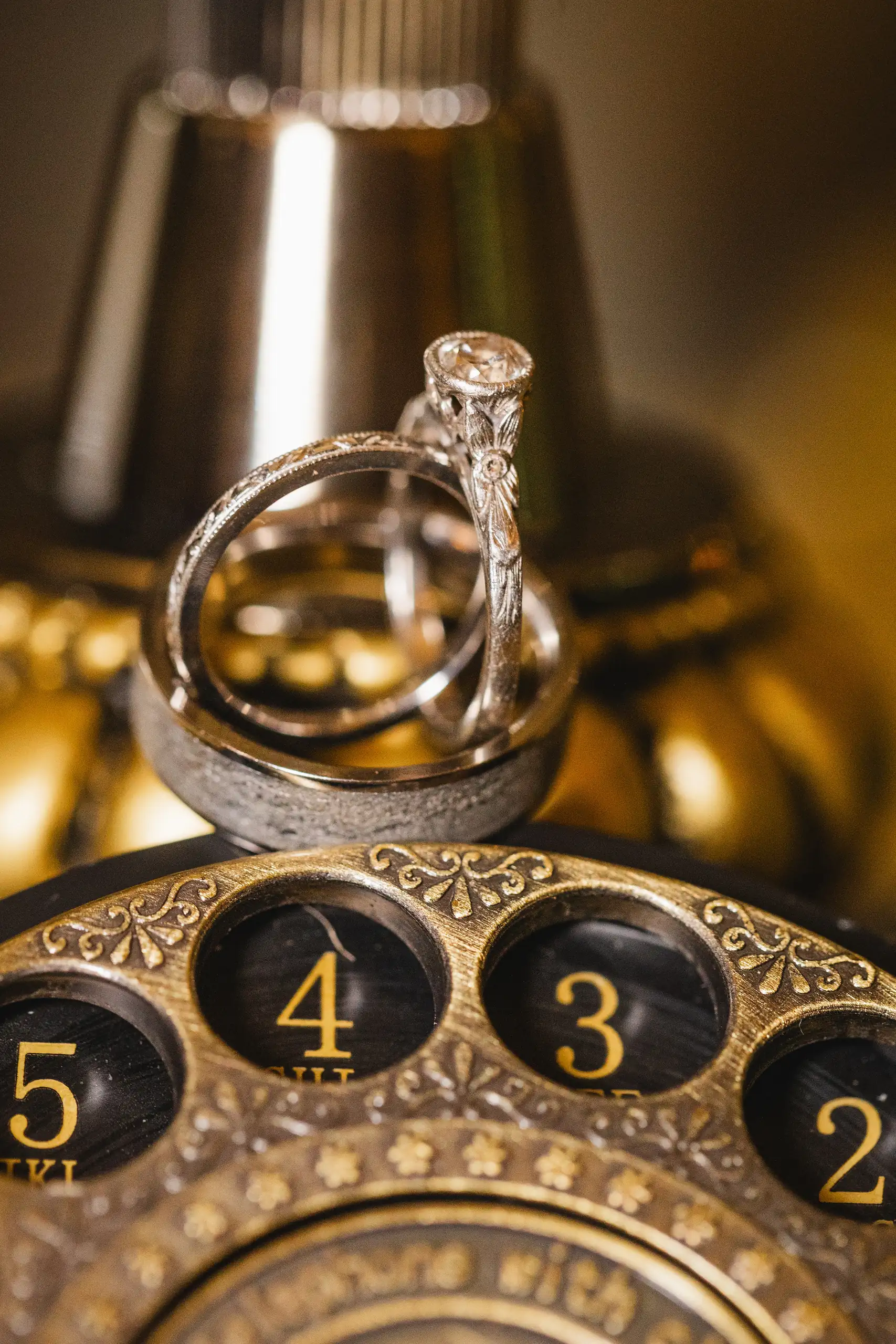 Wedding Details: the rings balanced on a brass telephone dial, at a wedding at Callanwolde Fine Arts Center in Atlanta, GA