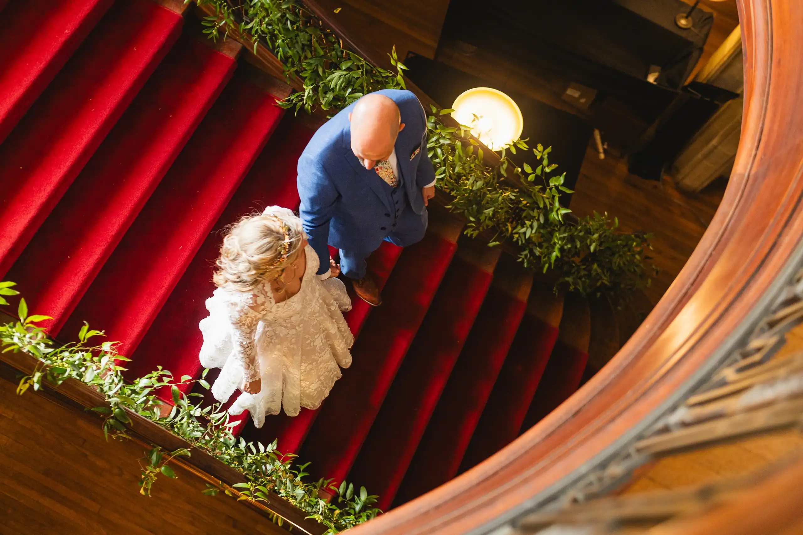 Wedding Formals: the couple on the red stairs, seen in a mirror, at their wedding at Callanwolde Fine Arts Center in Atlanta, GA